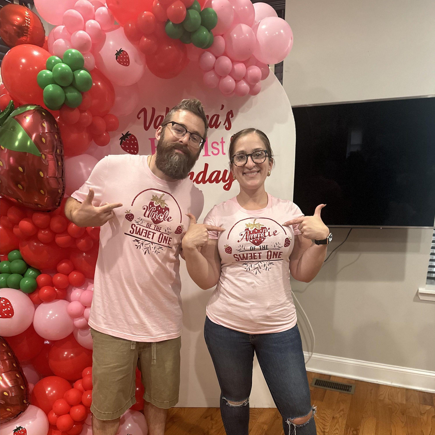 Pointing to the t-shirts I made us for Valentina's First Bday, and my friend Blanca's Balloon garland set up in the background.