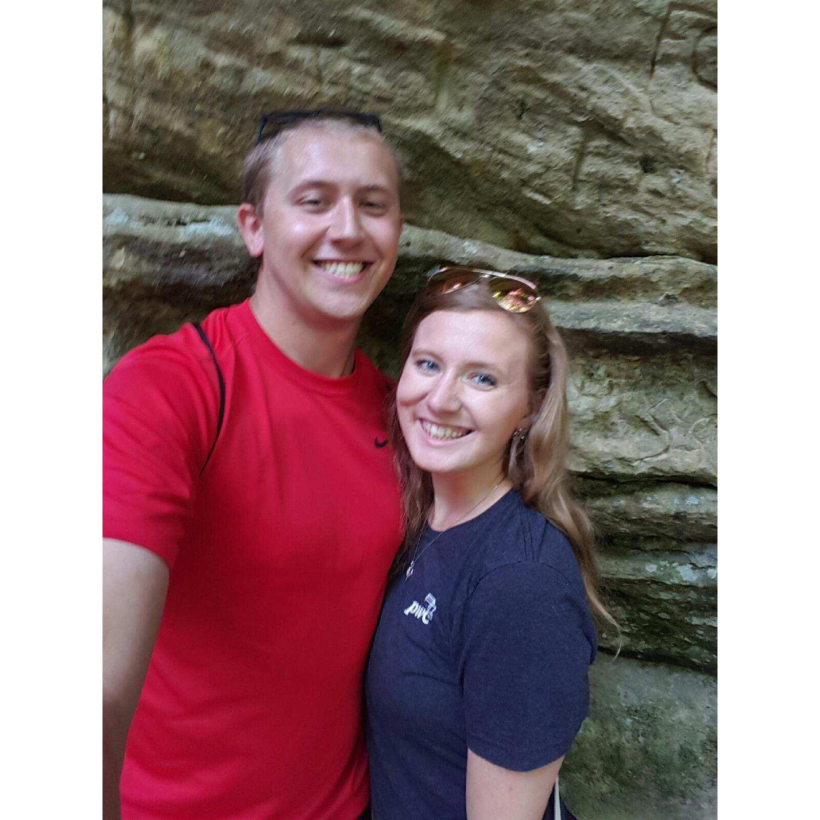 The couple stopping for a picture by the waterfall at Starved Rock State Park in LaSalle County, Illinois.