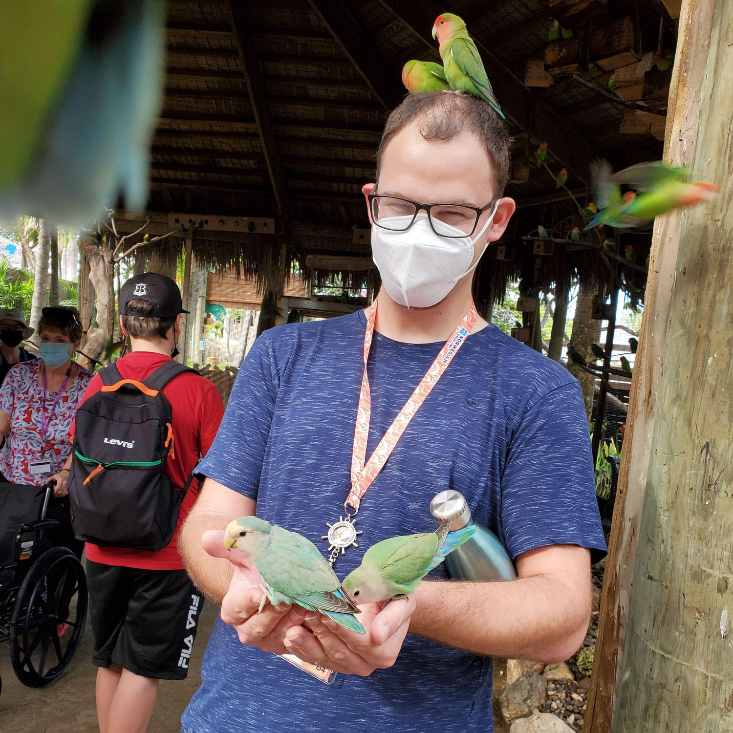Eduardo is very ATTRACTIVE. being swarmed in the bird exhibit.