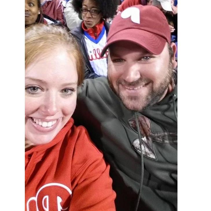 April 2015. Our third date at the Phillies game and the first photo we ever took together. With an awesome photo bomb in the background :P