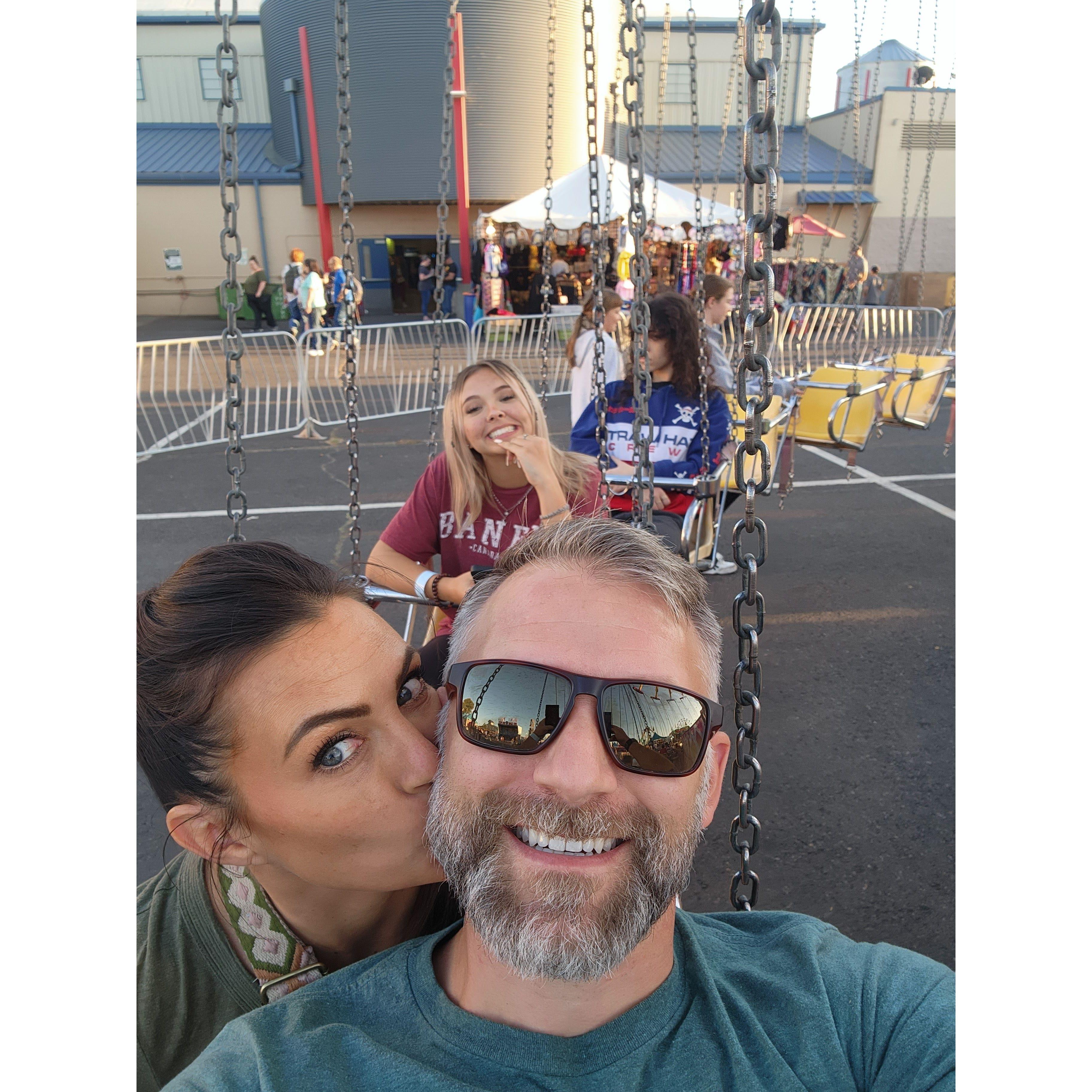 Taking the kids to the fair while they still want to hang out with us is more important to us than it was them.  Showing our love for each other almost everywhere we go.