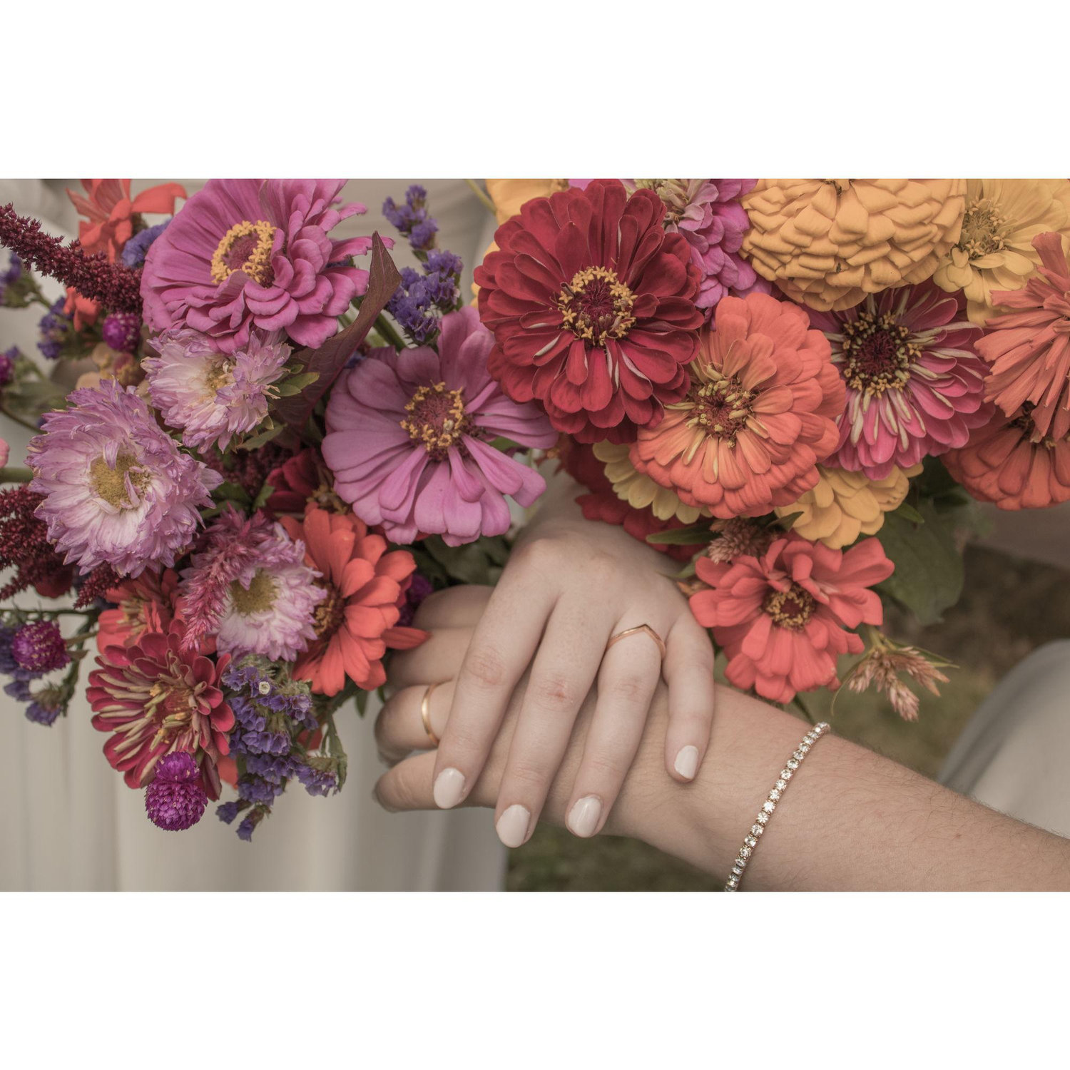 A close up of Lillian and Tabitha's bouquets and rings.