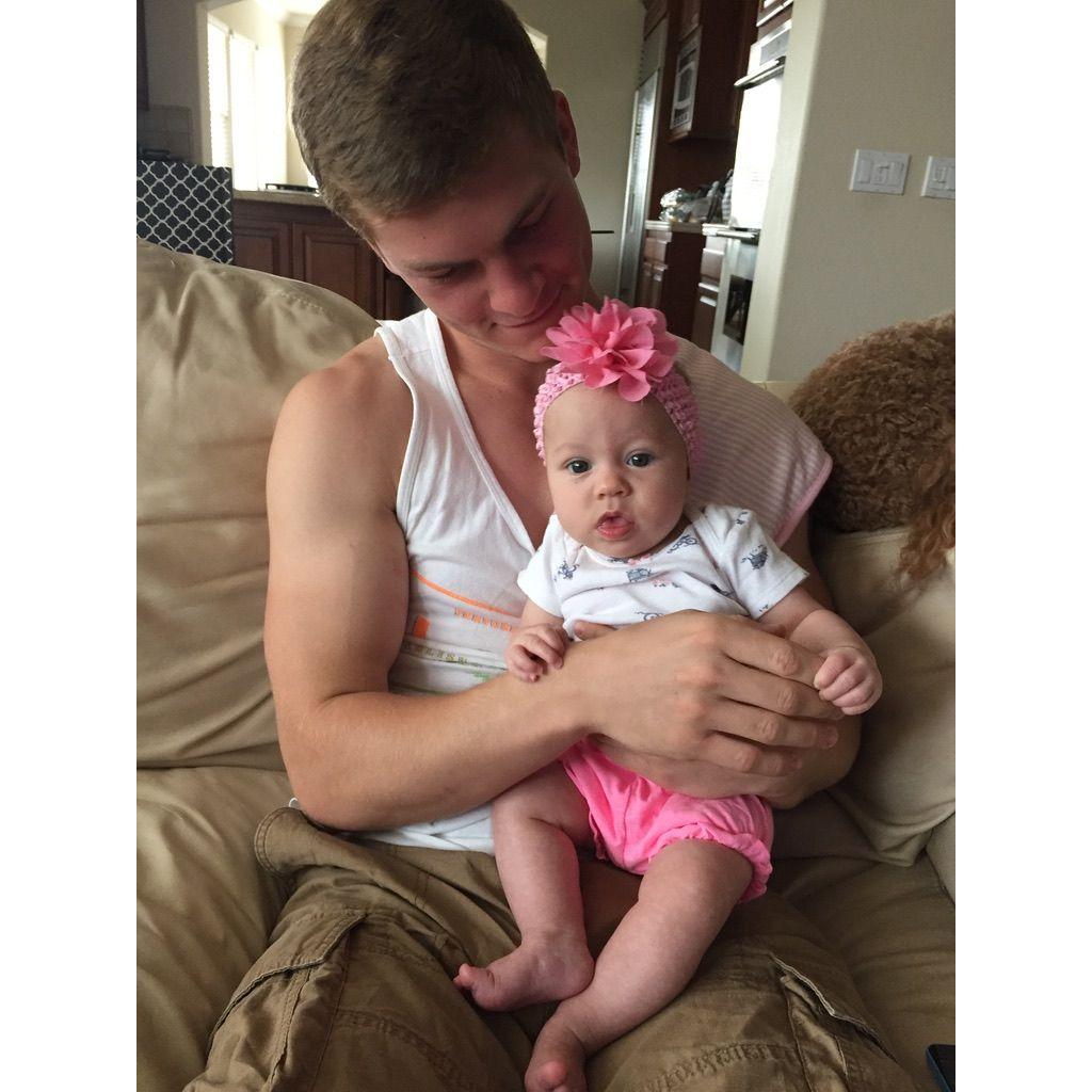 Flower girl, Felicity, sitting on Ross's lap! She was the first baby he had ever held. (2016)