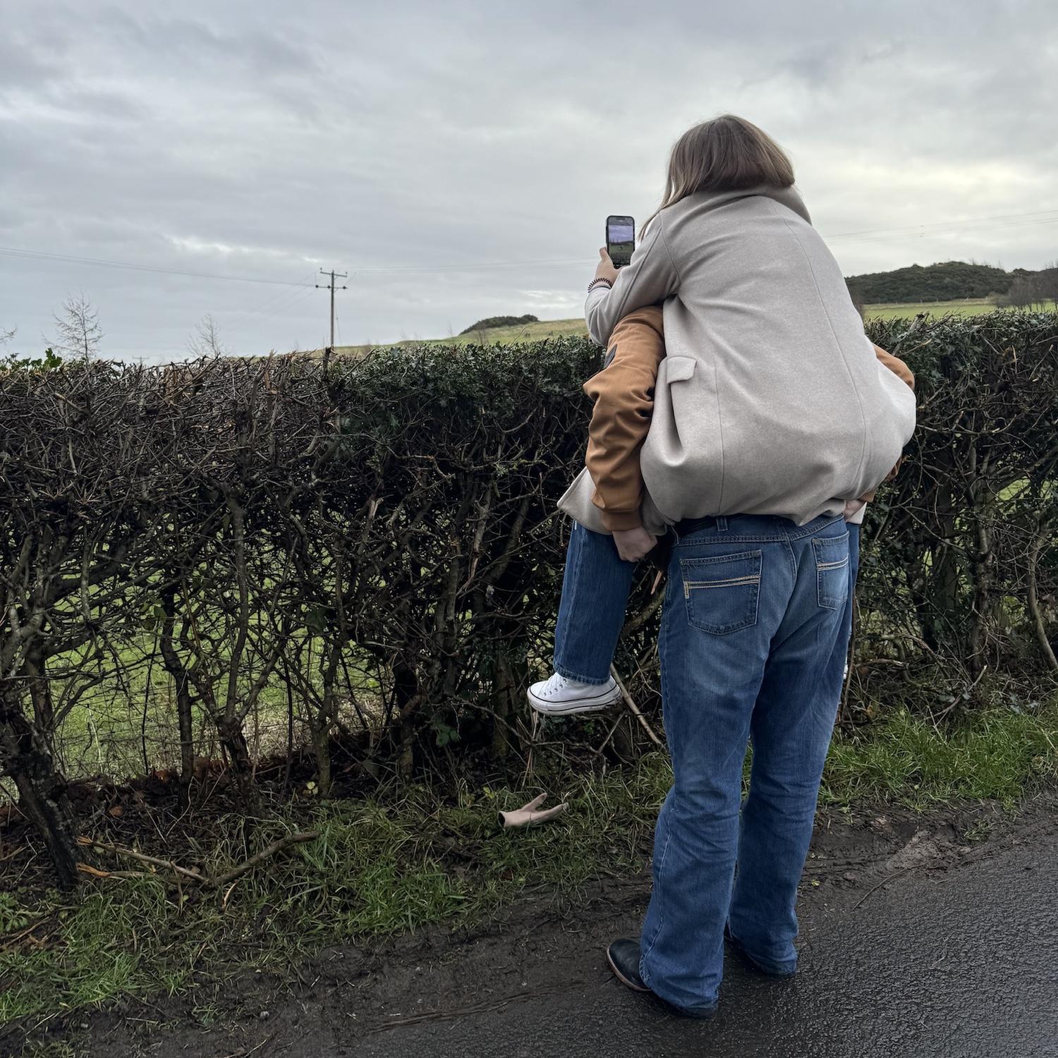 Lincoln helping Isabella take pictures of cows in Scotland