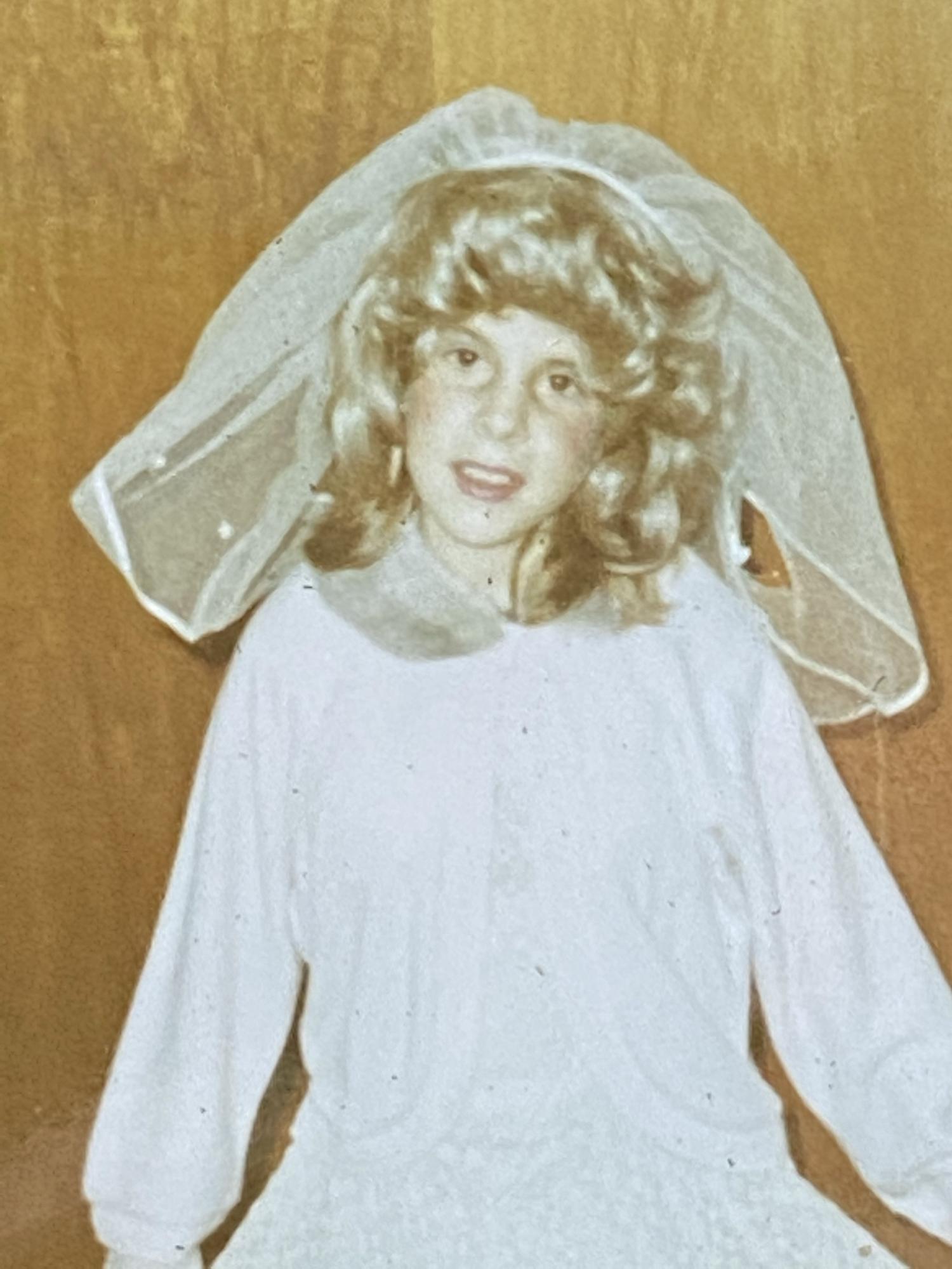 Young Carolyn practicing to be a bride