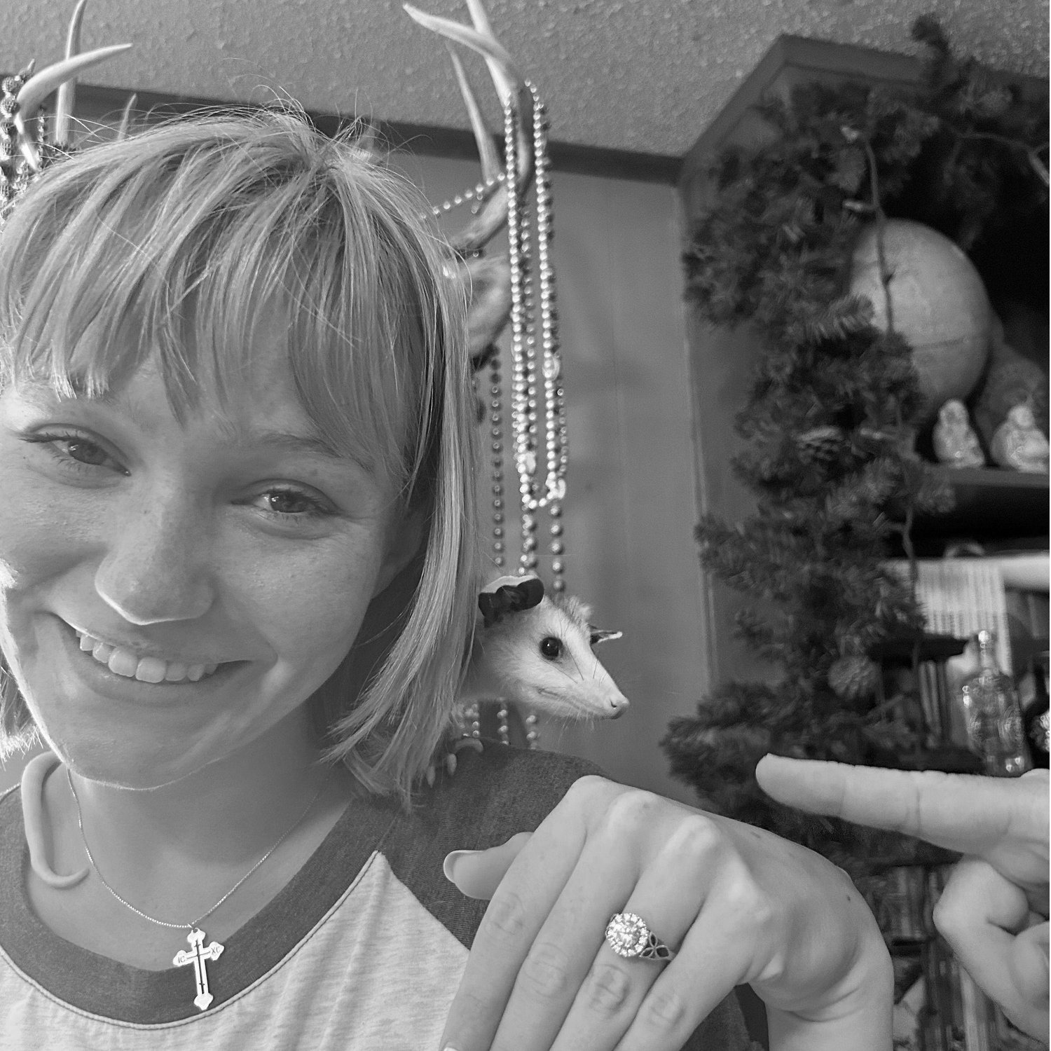 The Landreneaus' opossum posing with Paige and her new ring