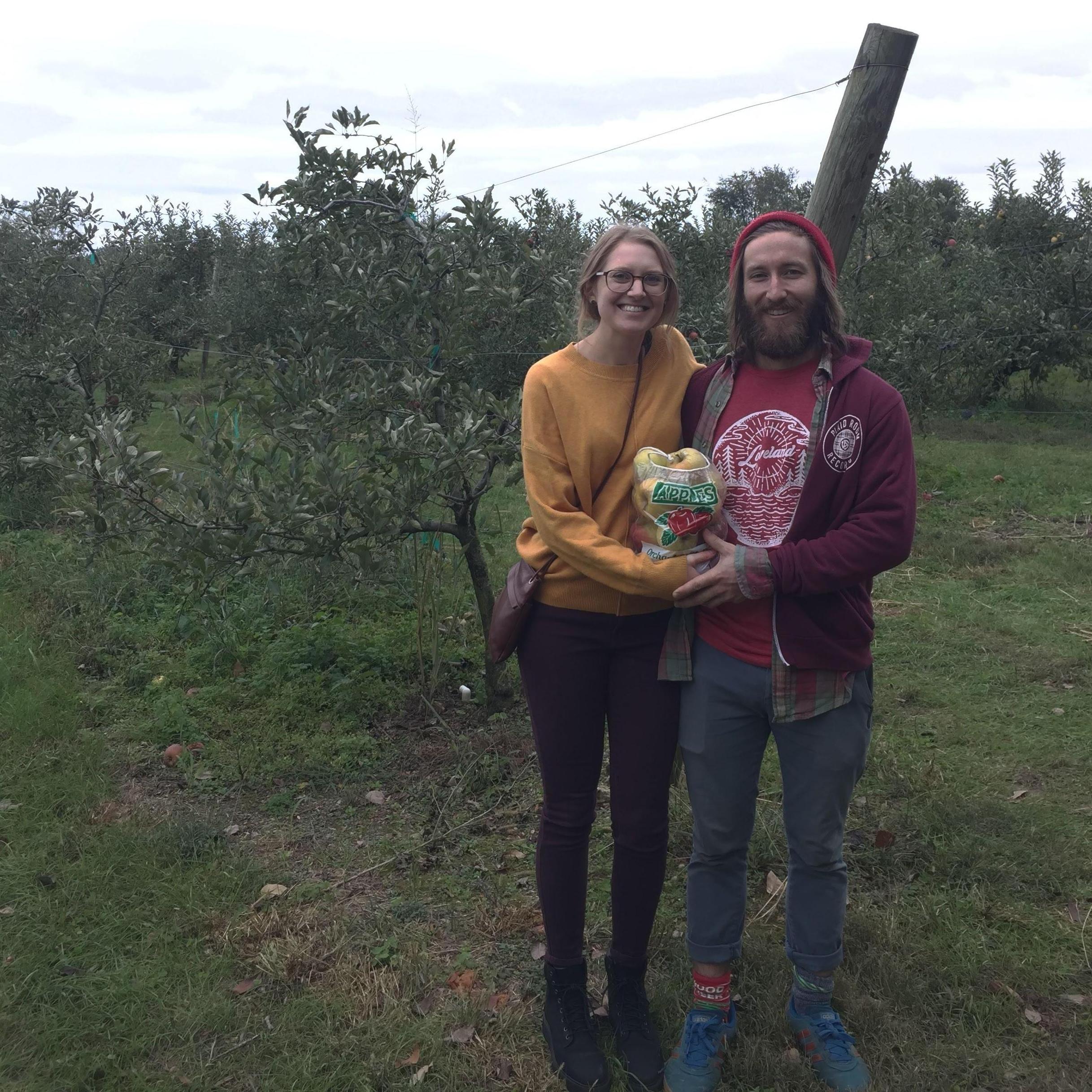 David's first apple picking experience! Holding their precious apple-bag-baby.
