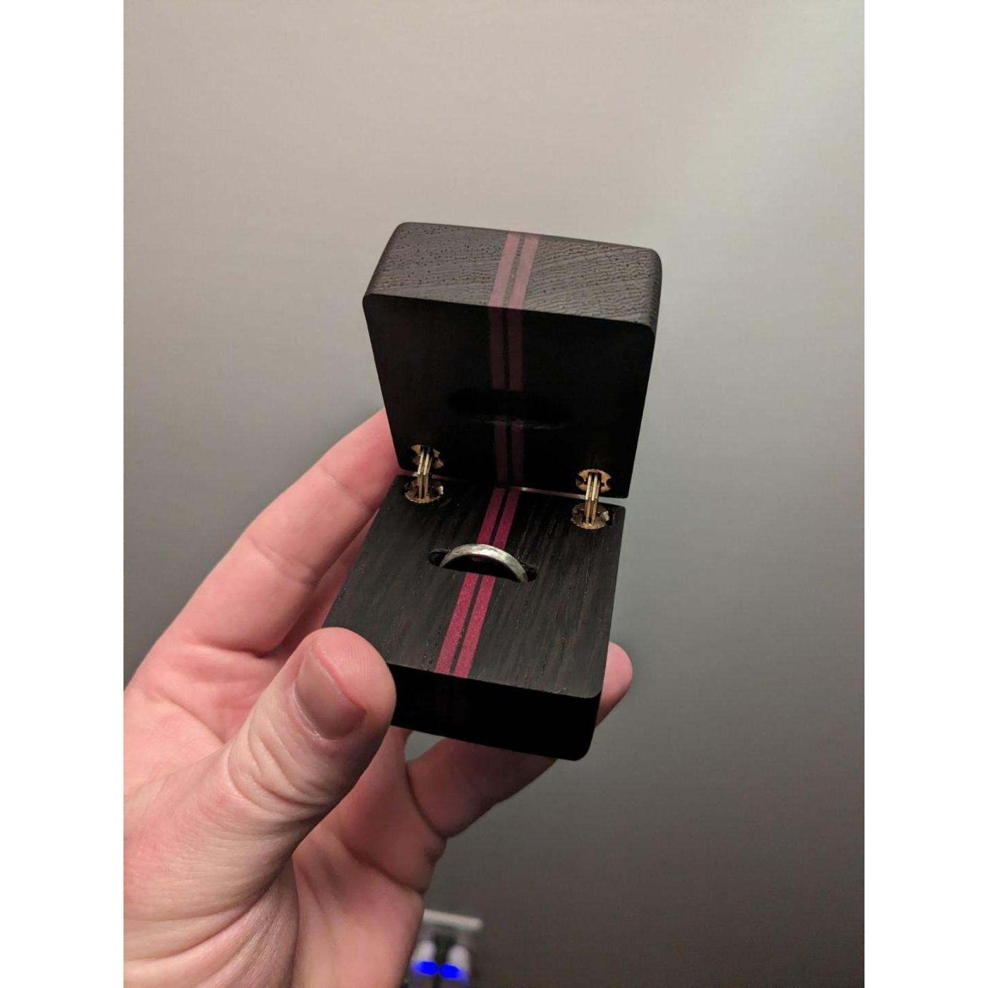 The engagement ring made by Nathaniel in the ring box made by Kenedie's dad!