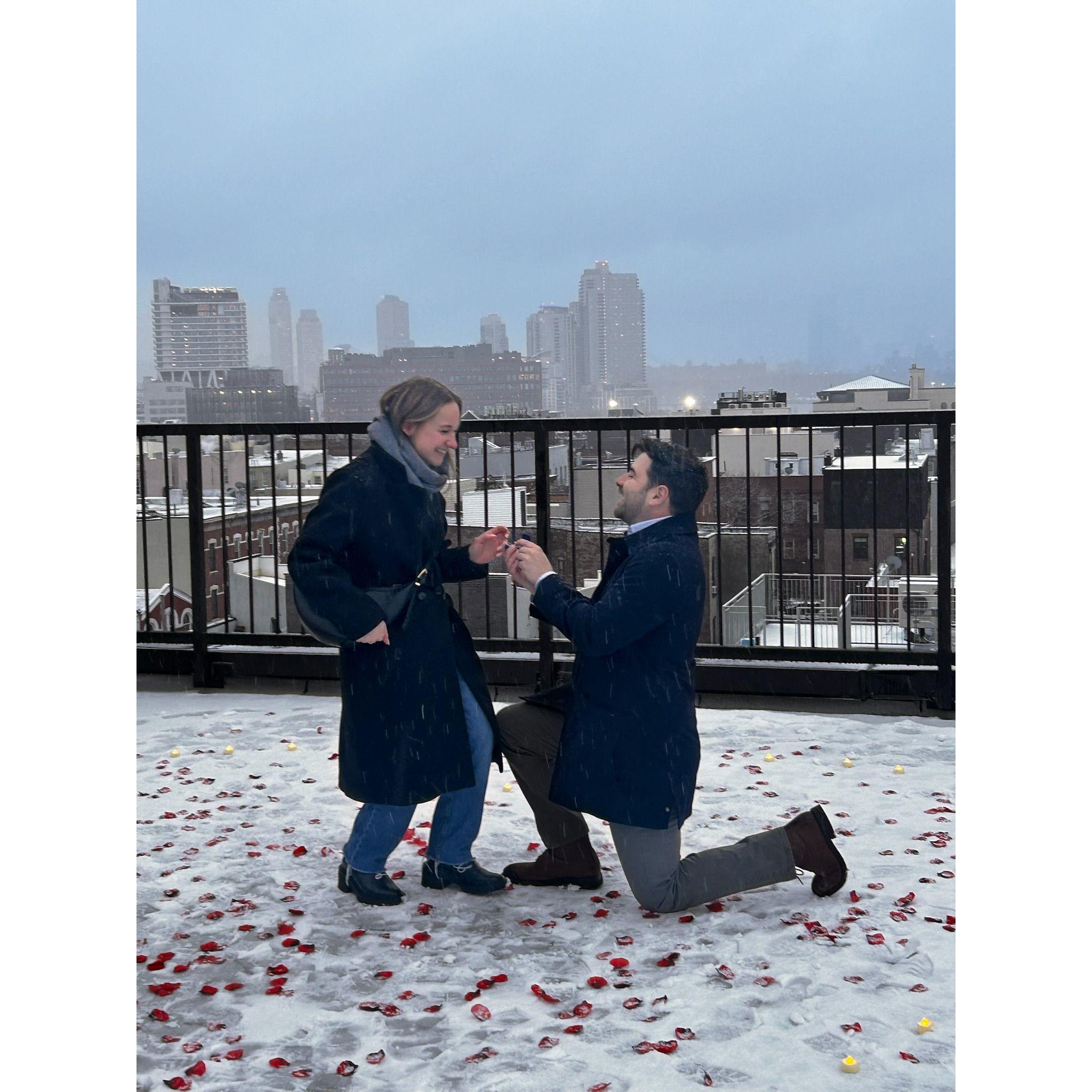 On February, 15, 2025, Chris proposed on our rooftop as the snow came down. It was perfect!