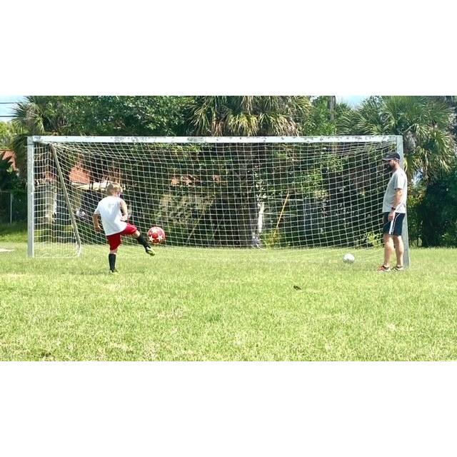 Luis is helping Cam with his soccer skills
