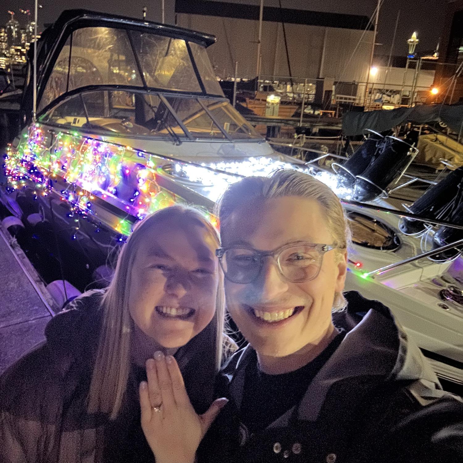 Mitch proposes on the boat, decorated in Christmas lights! December 2024.