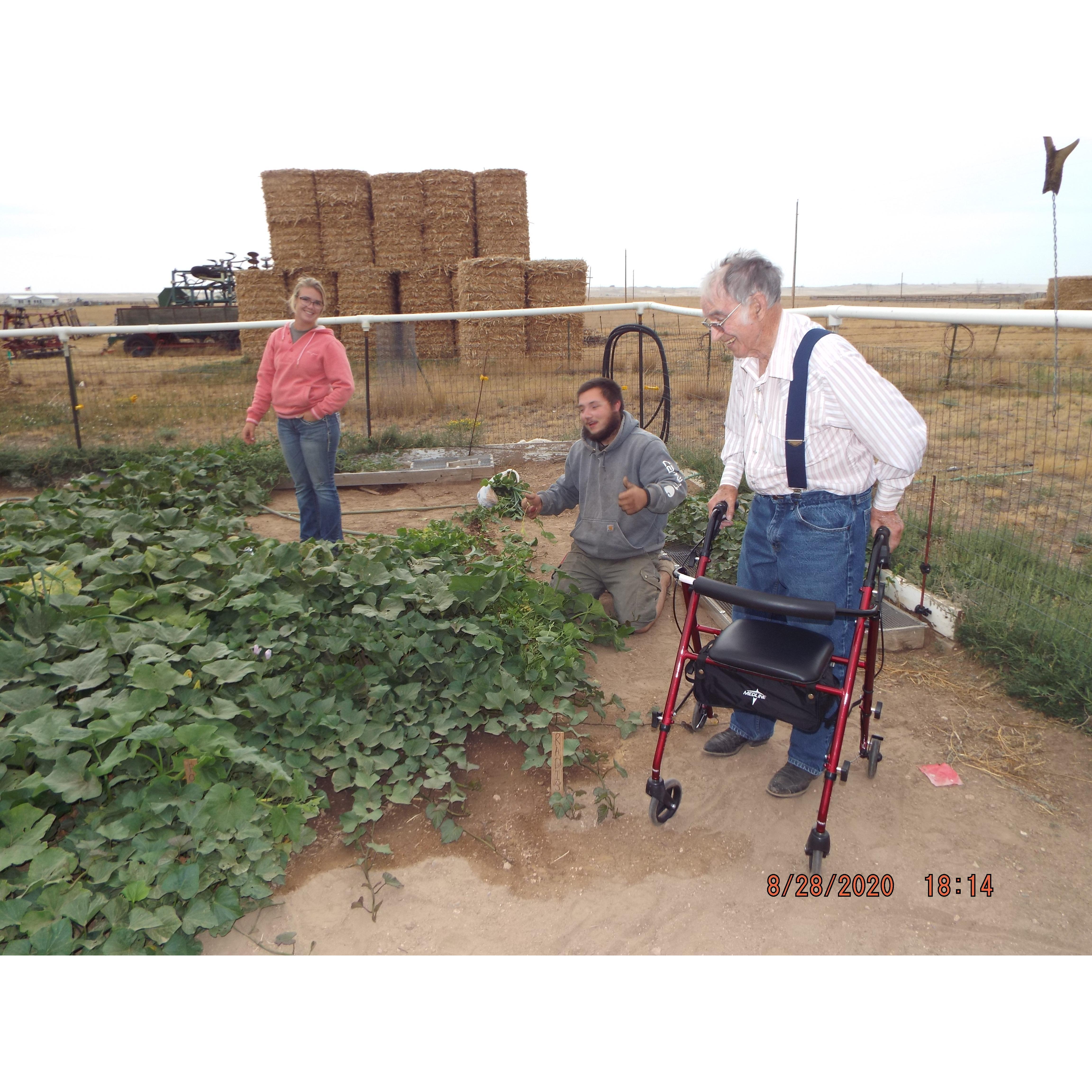 Bailey, Jordan and Bailey's grandpa, Howard in his garden before he passed