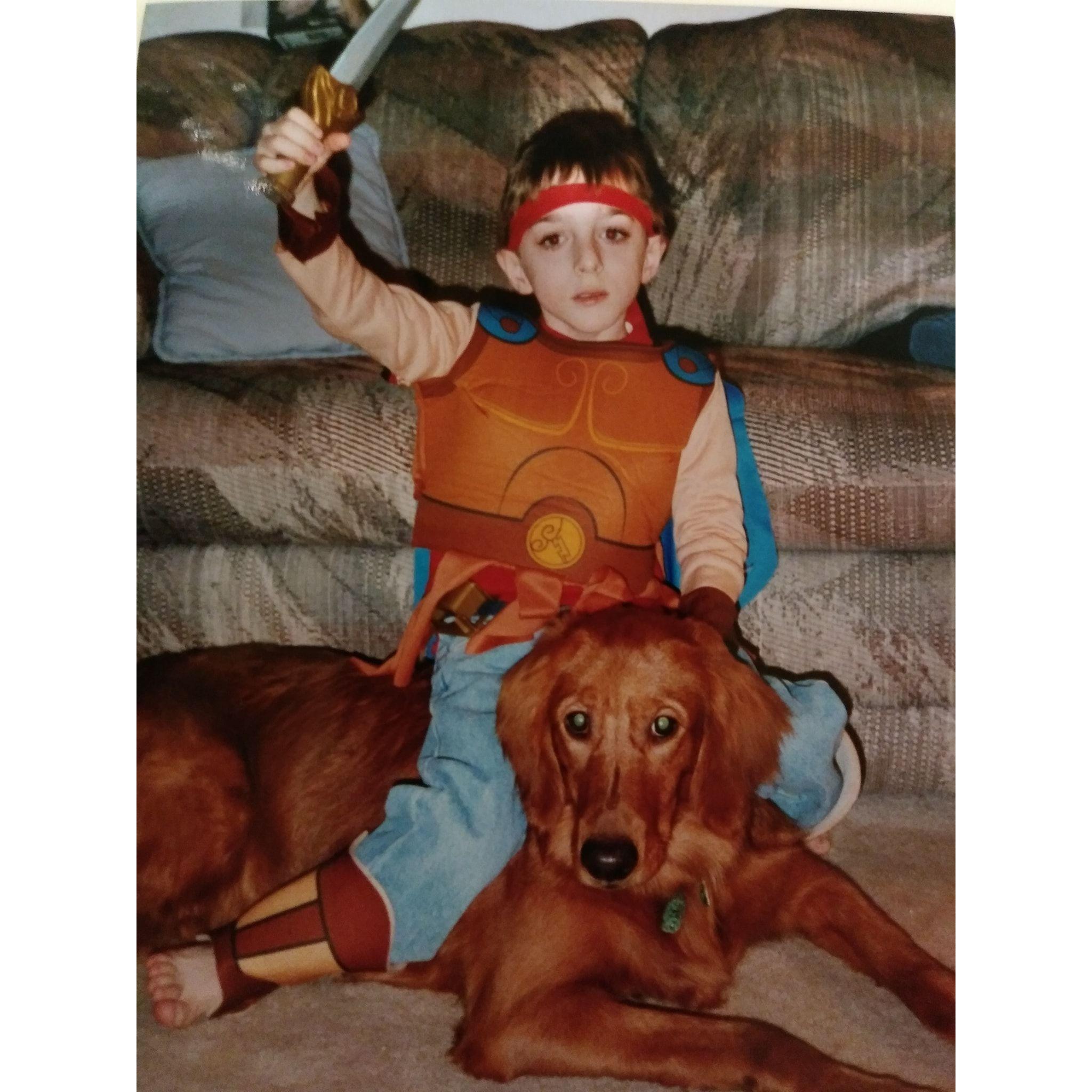 Sean with his first dog, Kaysie-girl while dressed as his favorite superhero, Hercules