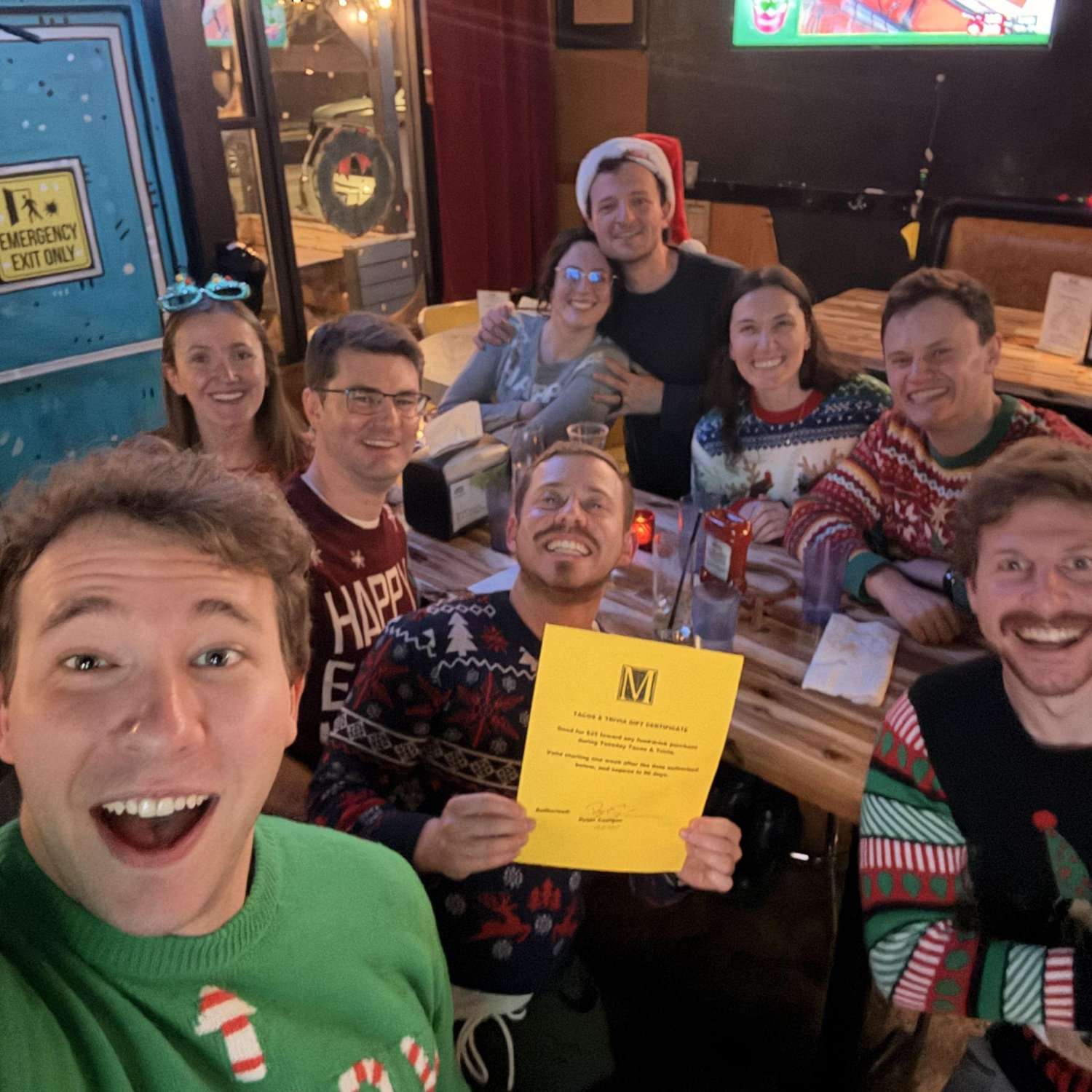One of our favorite week night traditions - Trivia night. Here we are holding a $25 gift card (!!!!!) that our team won (this was during the holidays so there were only 4 teams HA)