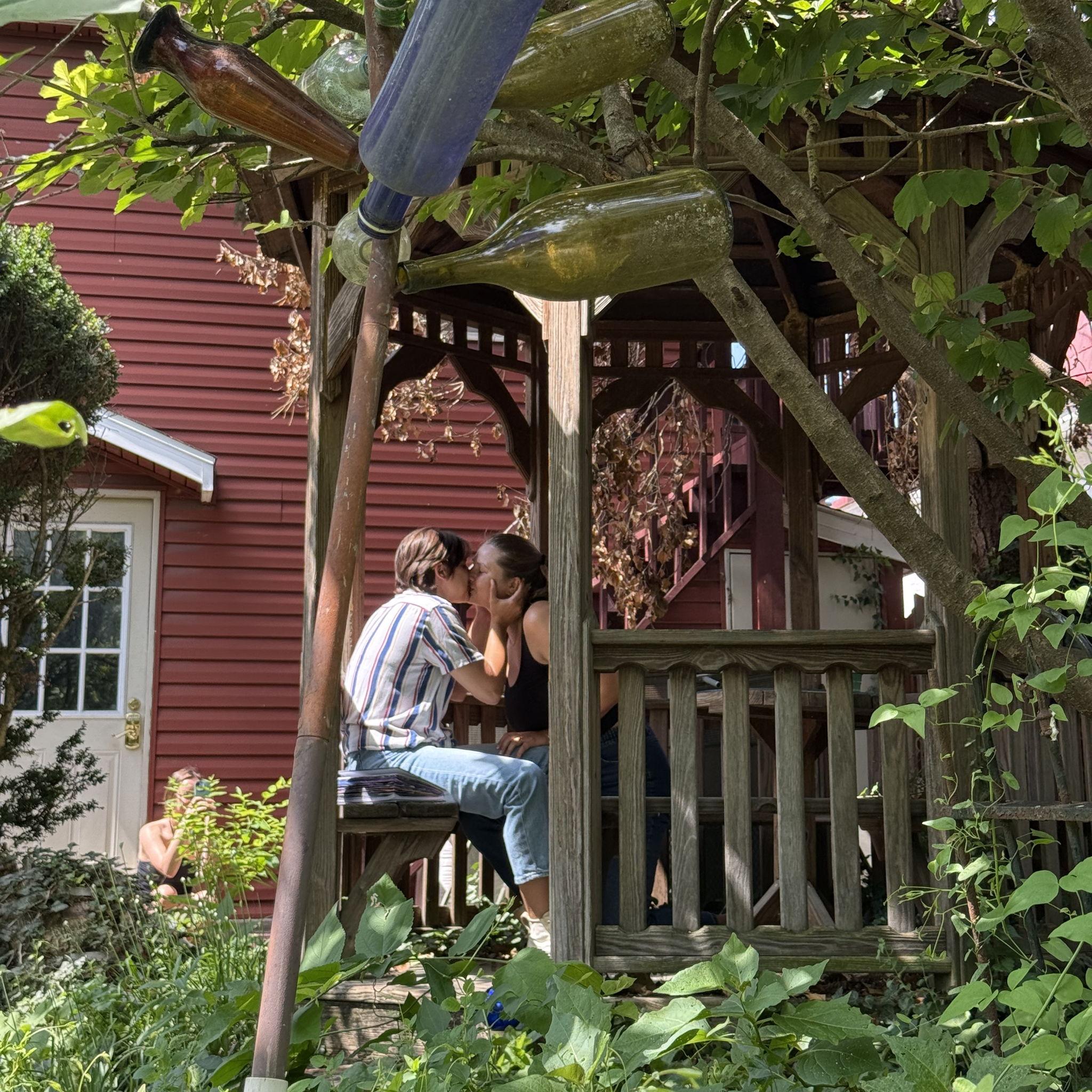 Hannah proposing at the gardens behind Rosemary House