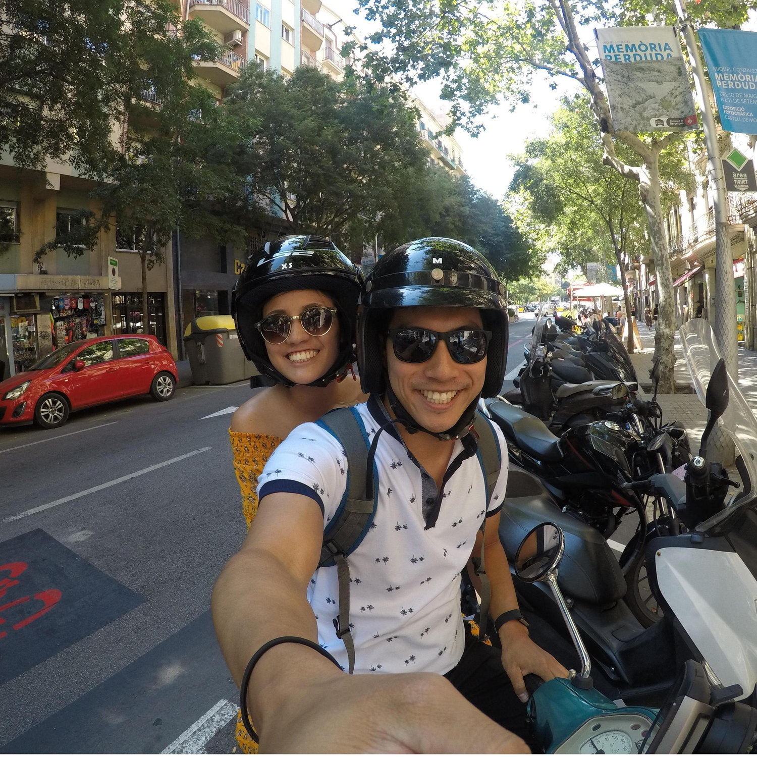 Riding on a Vespa through the streets of Barcelona.