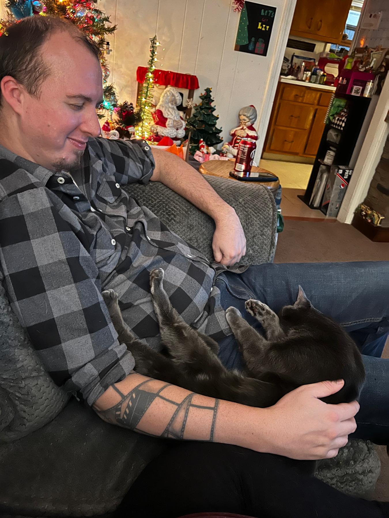 New Year's Eve of 2022, with his "son" Mandalorian, who always melts into his lap when we have movie nights