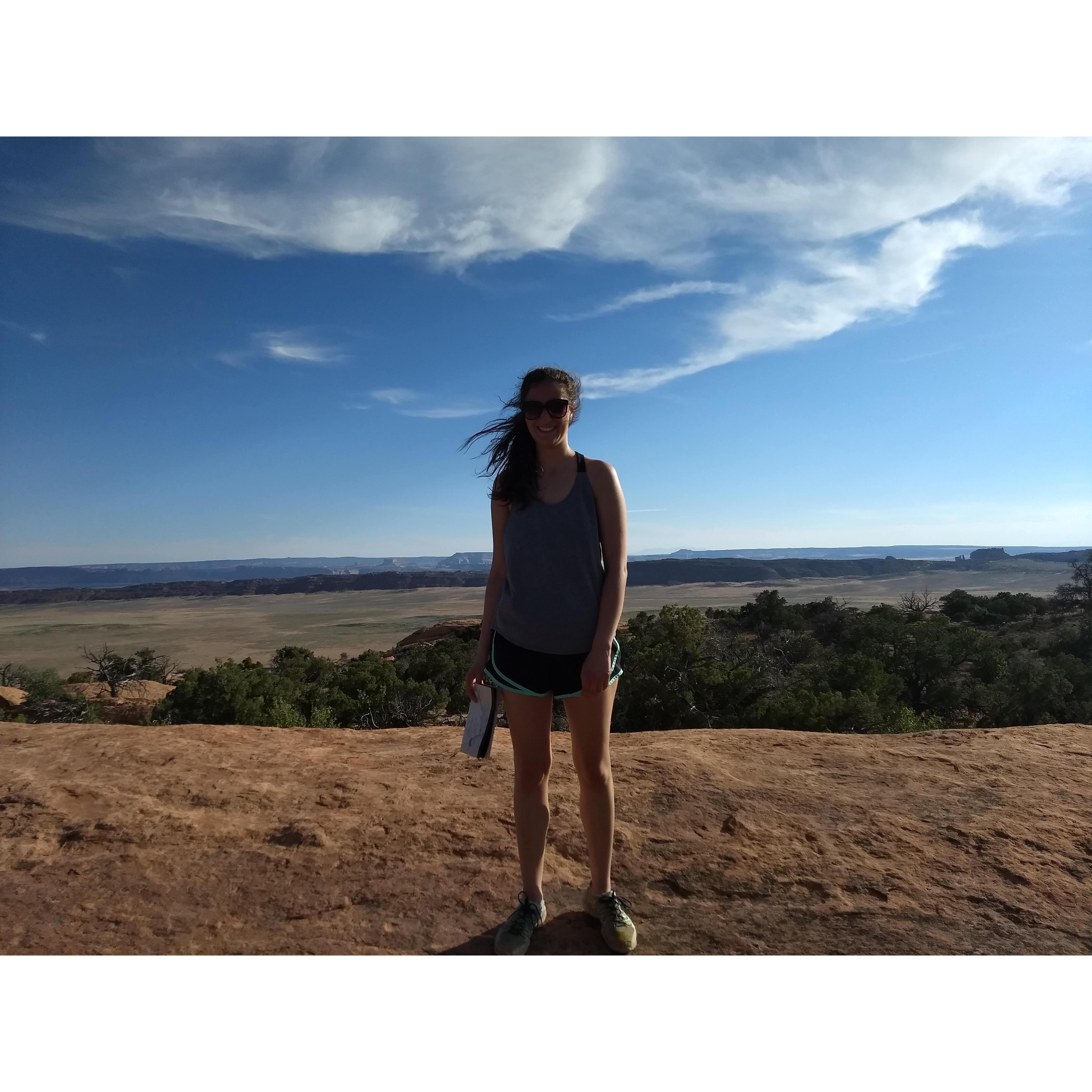 Amy gauging the wind during a hike at Arches National Park!