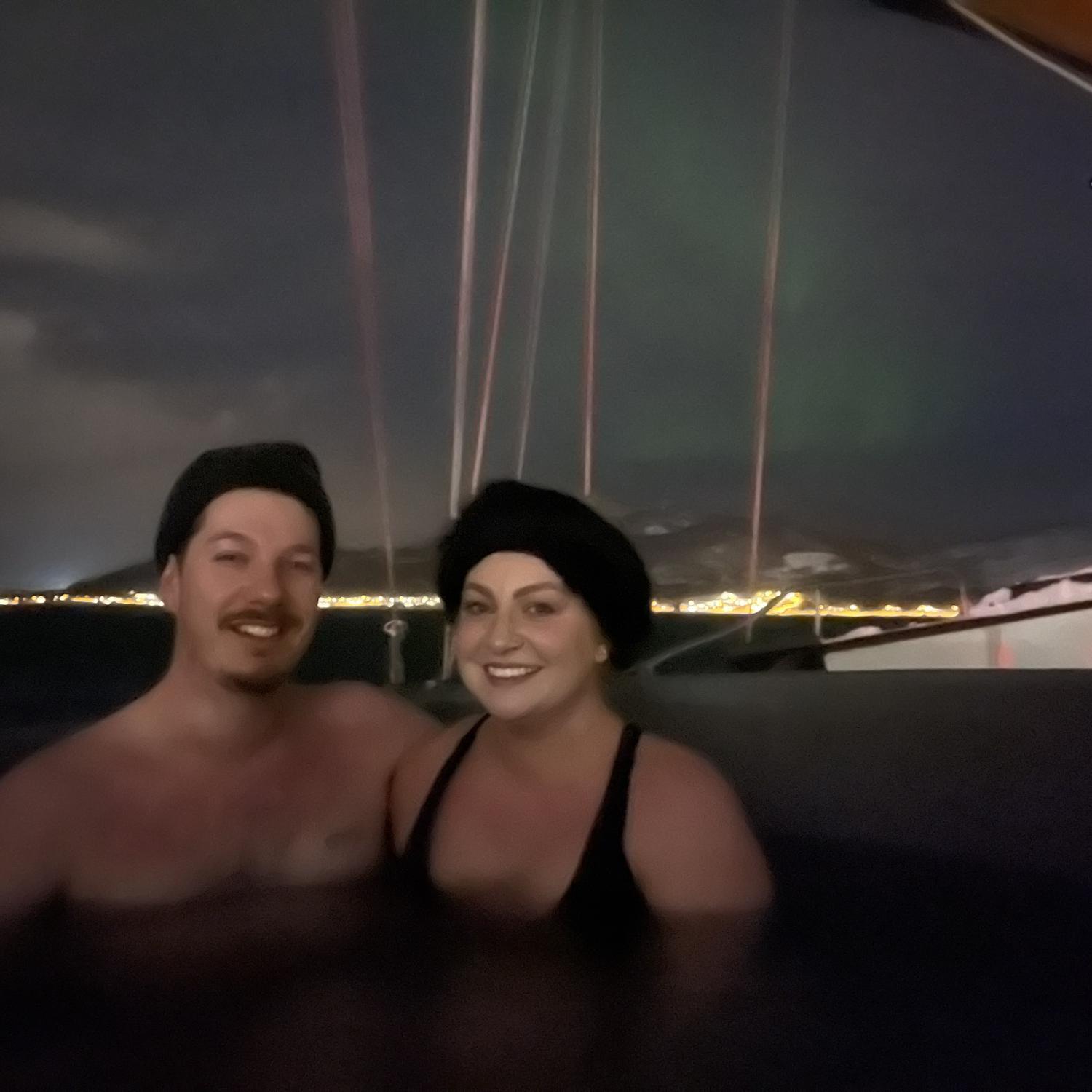 In a hot tub on a boat in the Arctic under the Northern lights! Gabrielle had no idea that an hour from this photo Darren would propose!