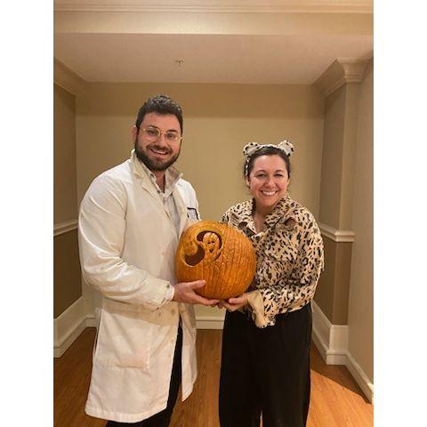 Halloween together a year later. Holding our carved pumpkin!