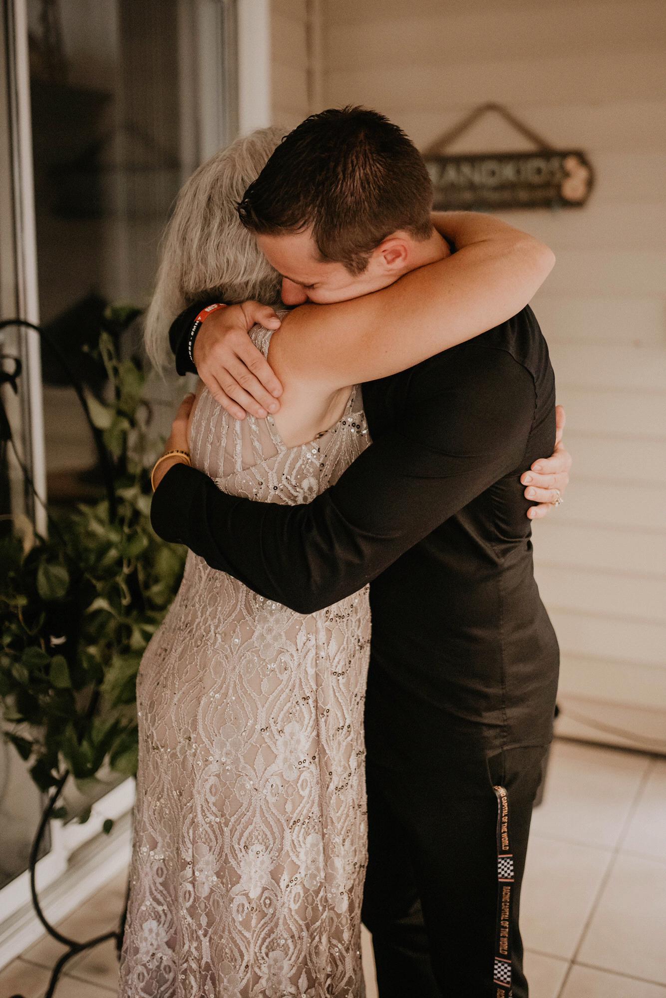 A hug from mom before the groom hit the isle!