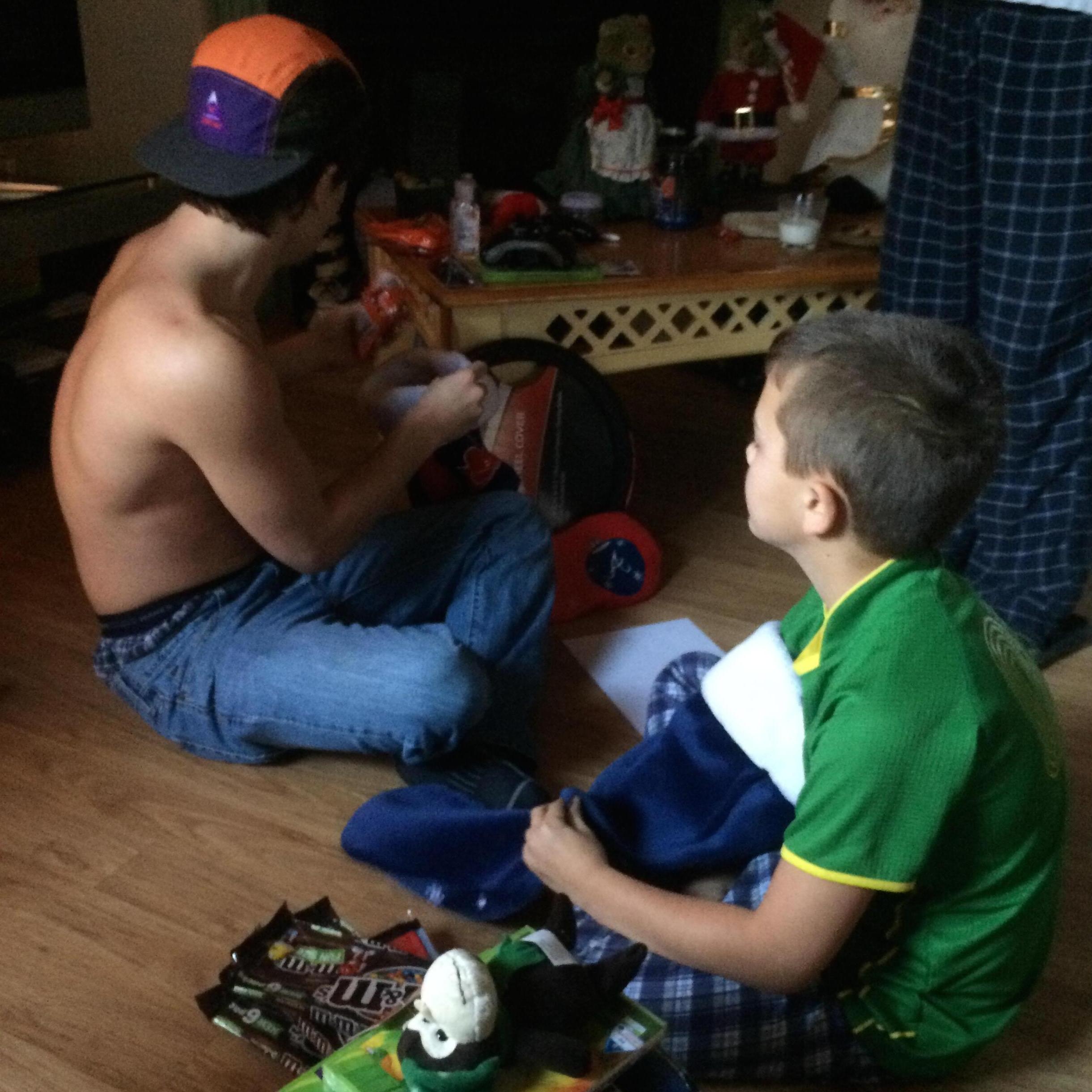 Cody and Carter opening gifts