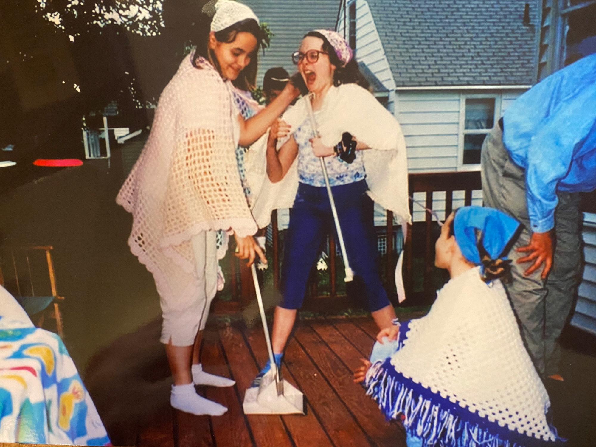 Caroline, Julia, and cousin Lisa Anne acting out “America” from West Side Story during one of their many “shows” they’d put on at family gatherings, here at their grandmother’s old shore home.