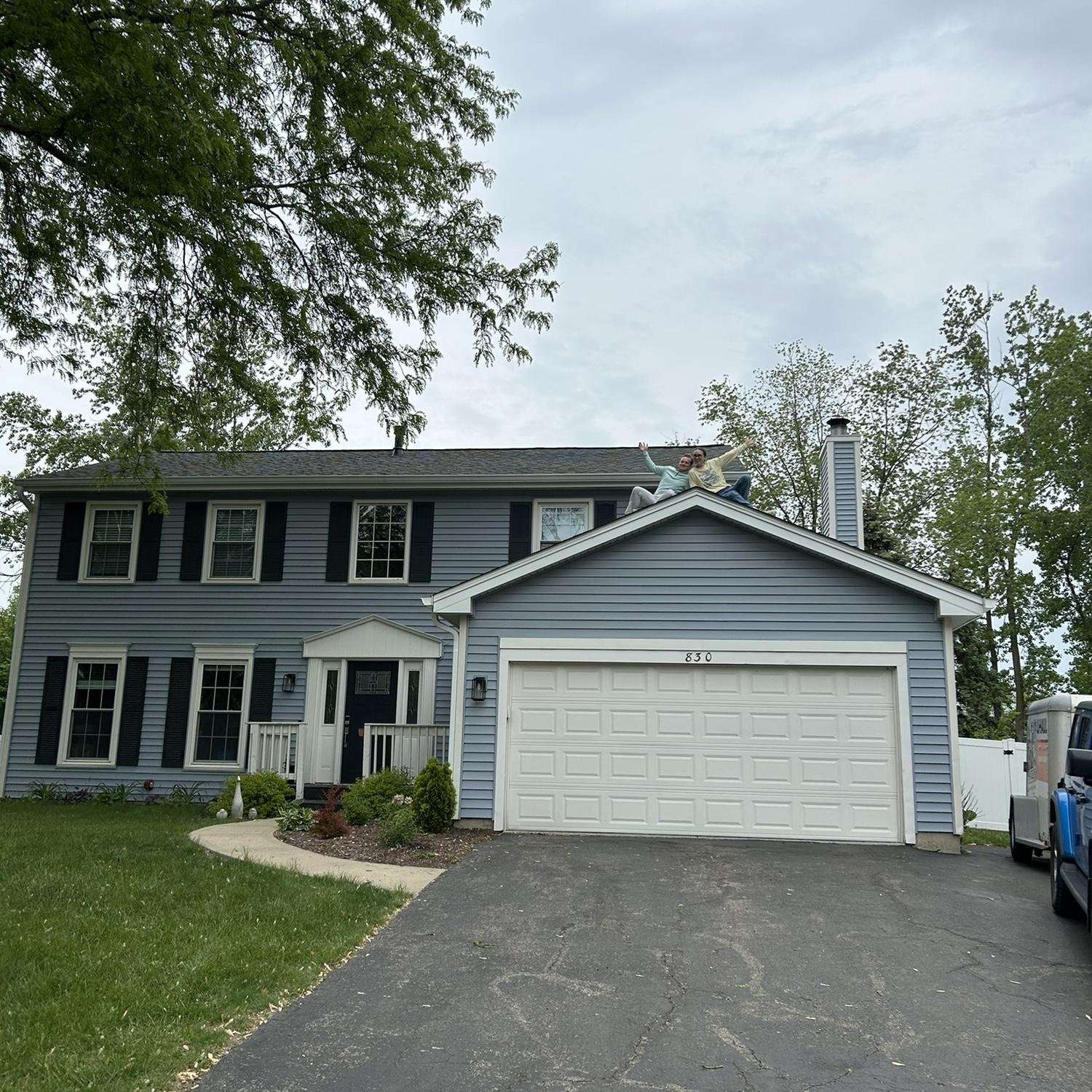 Kristen and Sean bought a house! They are in fact on the roof in this photo!