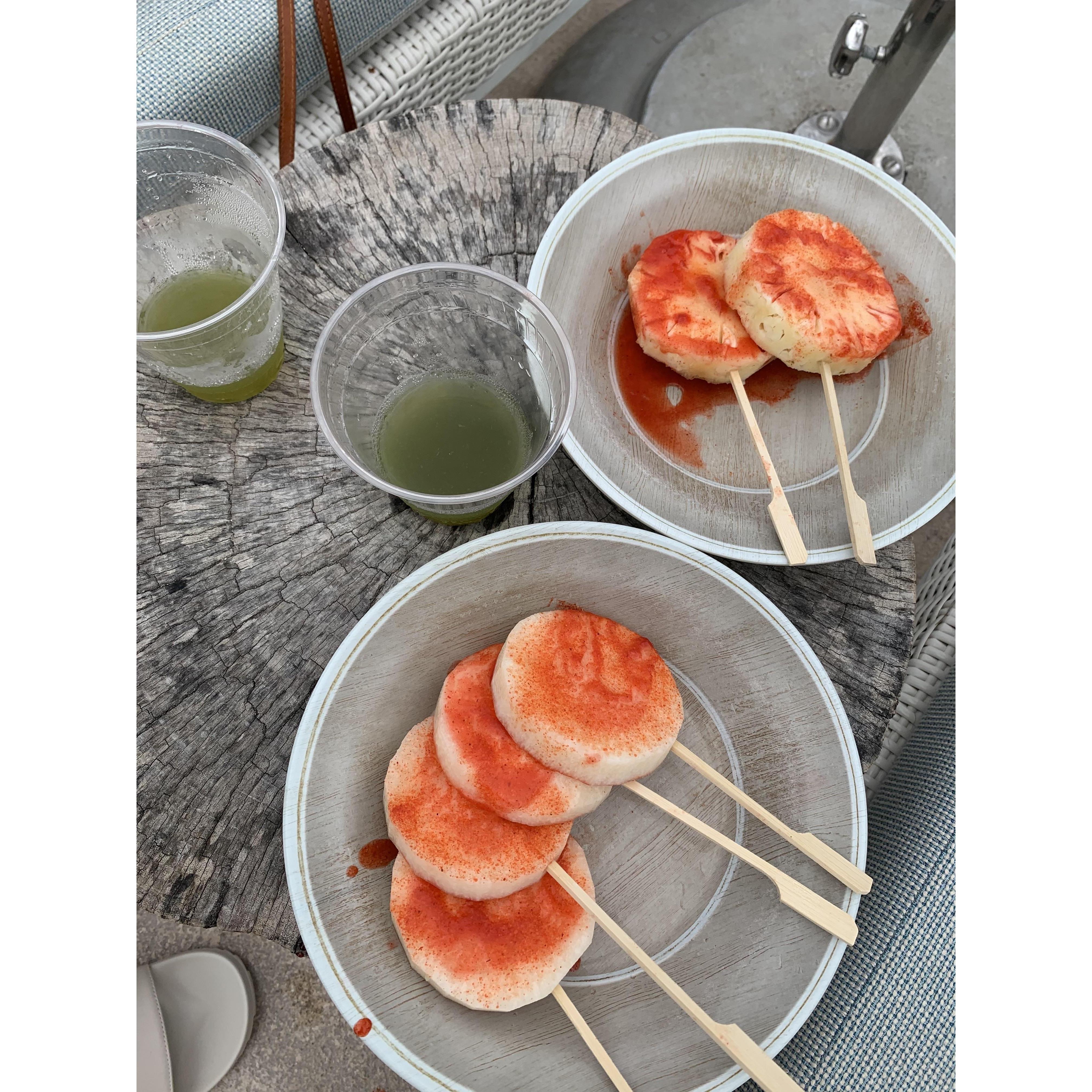 Jade Drinks by the pool and jicama and pineapple with chamoy!