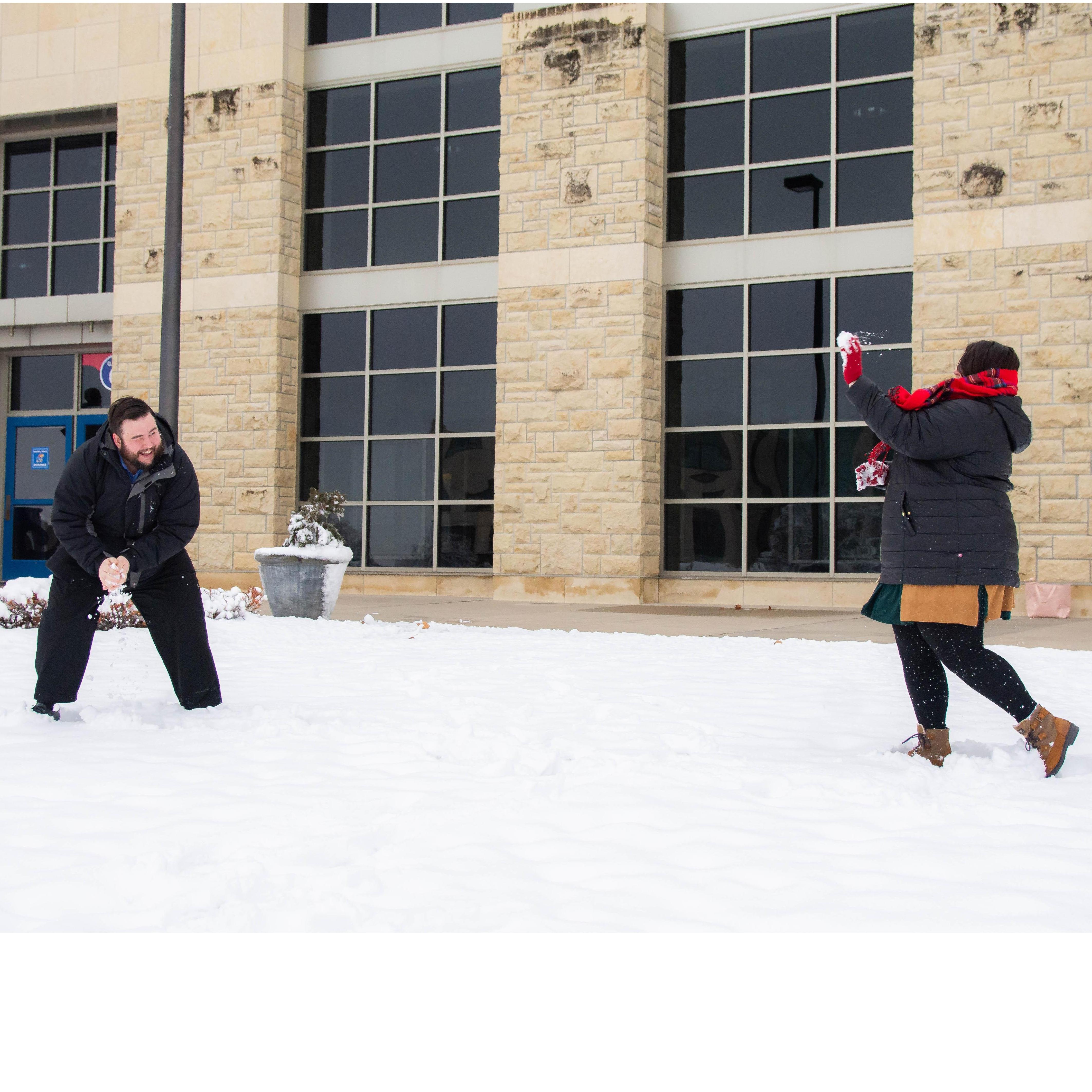 Having a snowball fight in front of our favorite place, Allen Fieldhouse!