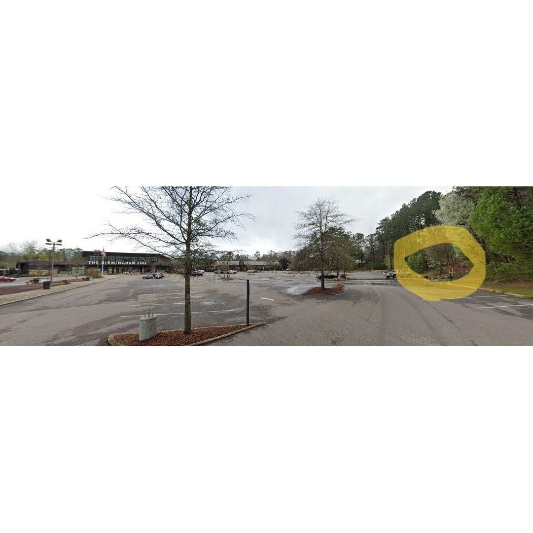After entering the Zoo gates from the round-about, keep moving forward until you reach the main parking lot. Keep to the right, along the parking lot border, and you should see the Lodge signage.