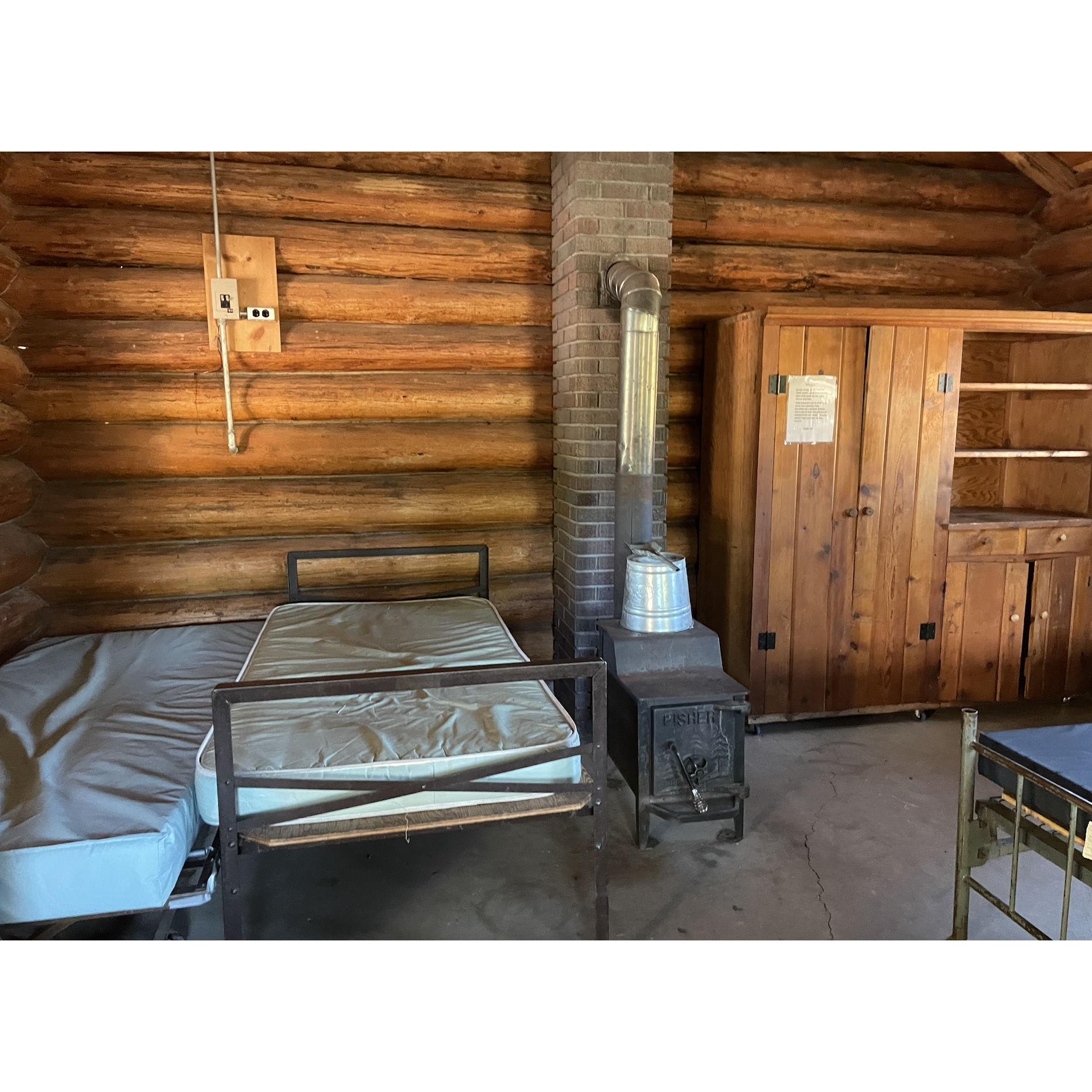wood stove and single beds style cabin