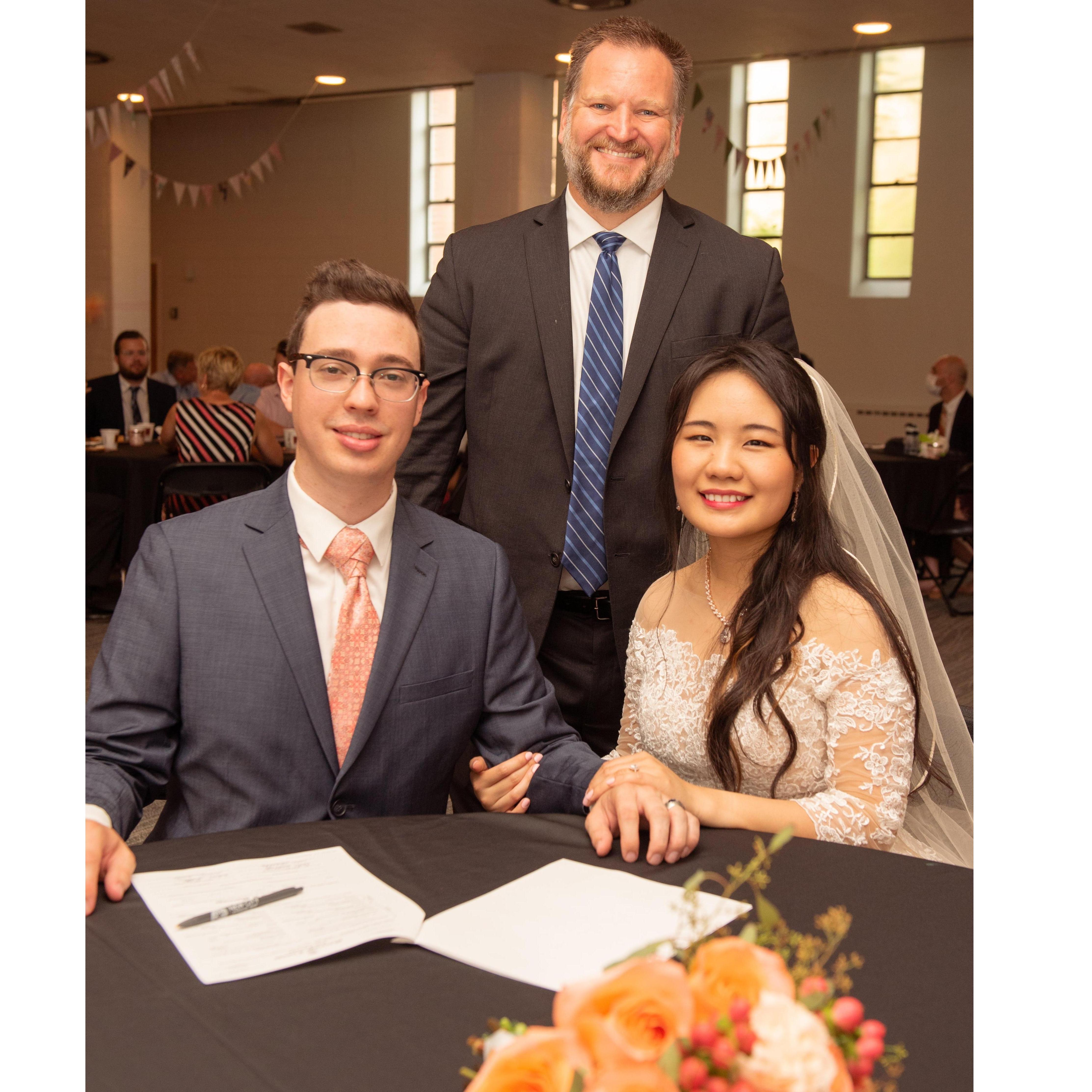 signing marriage license with pastor Matt.