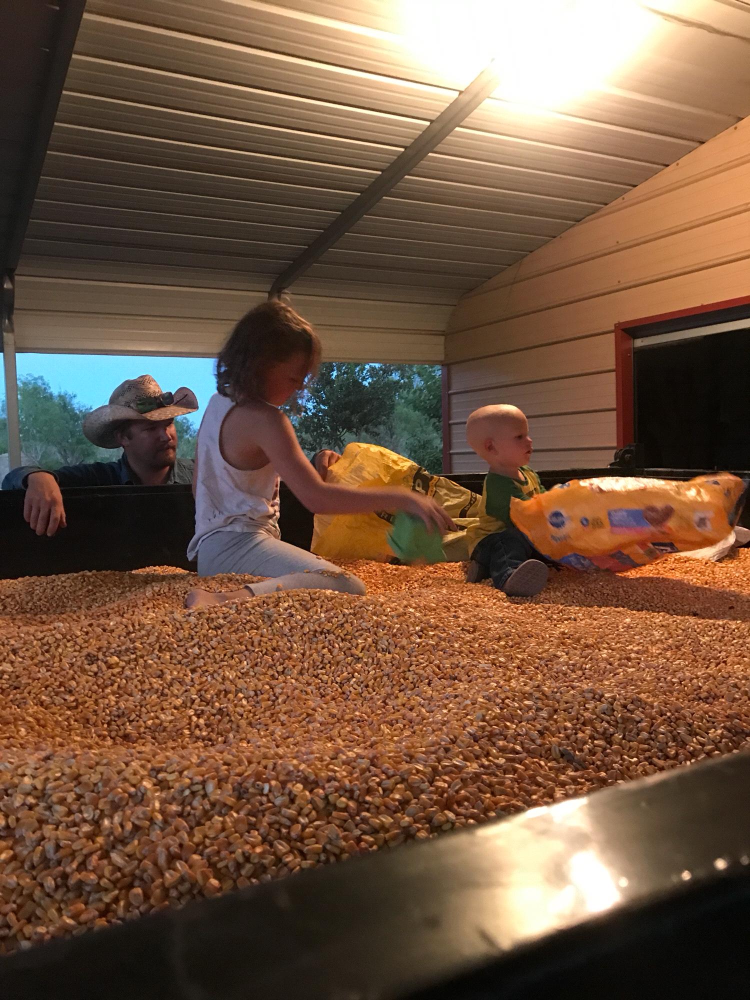 Madison and Aron sacking corn we picked up from Papaw and Uncle Joe
