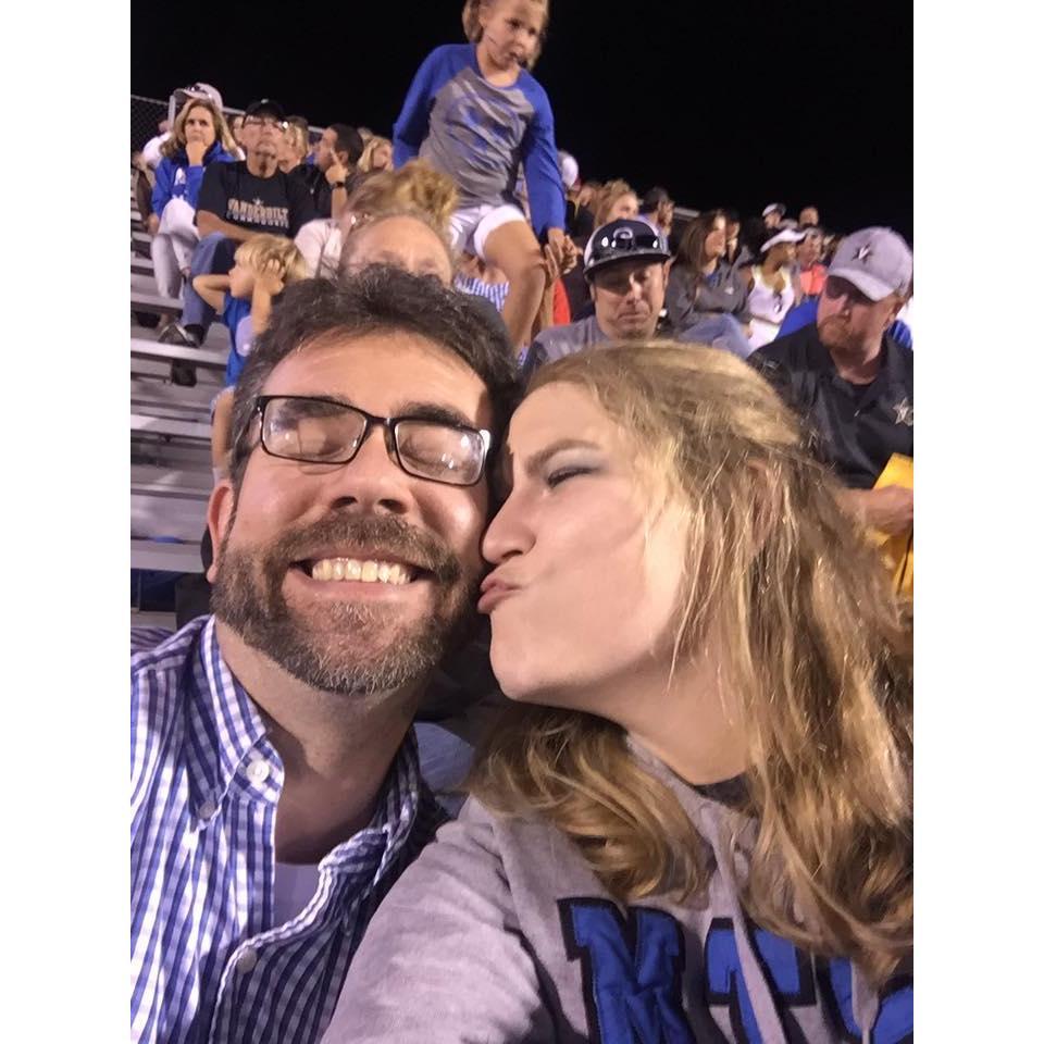 A football game at Cameron's alma mater. He was cheering for the other team and her team lost horribly, but they still had a pretty good time.