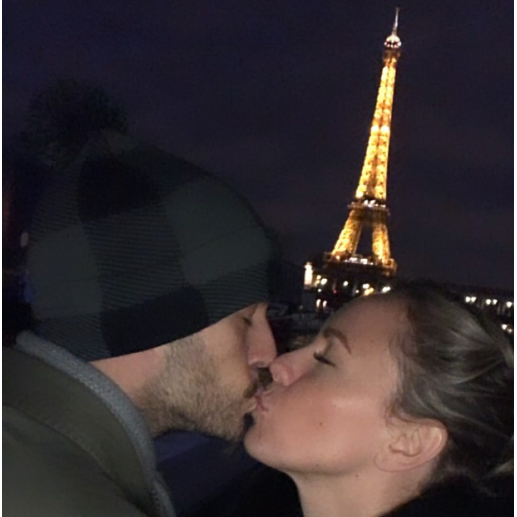 Sharing a kiss at the Eiffel Tower in Paris.