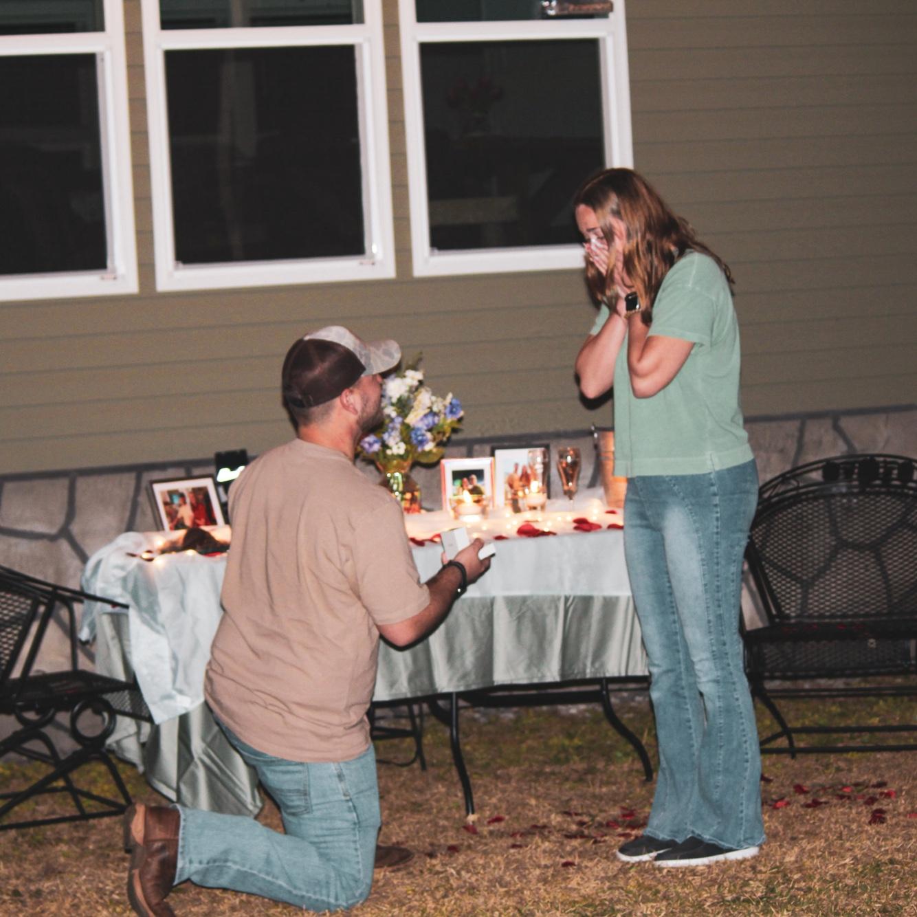 He built a pergola just for this night (it’s not in the photo, but it’s right above us, strung with lights he hung himself 🥹). Then he got down on one knee and asked me to marry him. 💍✨