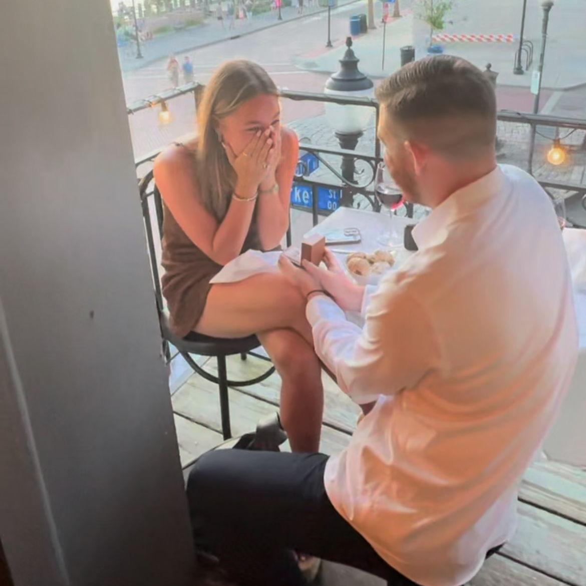 Kevin proposed to Alexa on July 1st, 2025, in Wrightsville, NC. The two were visiting Carolina Beach to celebrate their four-year anniversary. In celebration, they visited Floriana for an anniversary dinner. After watching the sunset on their private balcony, the server brought out dessert and revealed the ring box. Alexa was shocked, to say the least, but she said yes!
