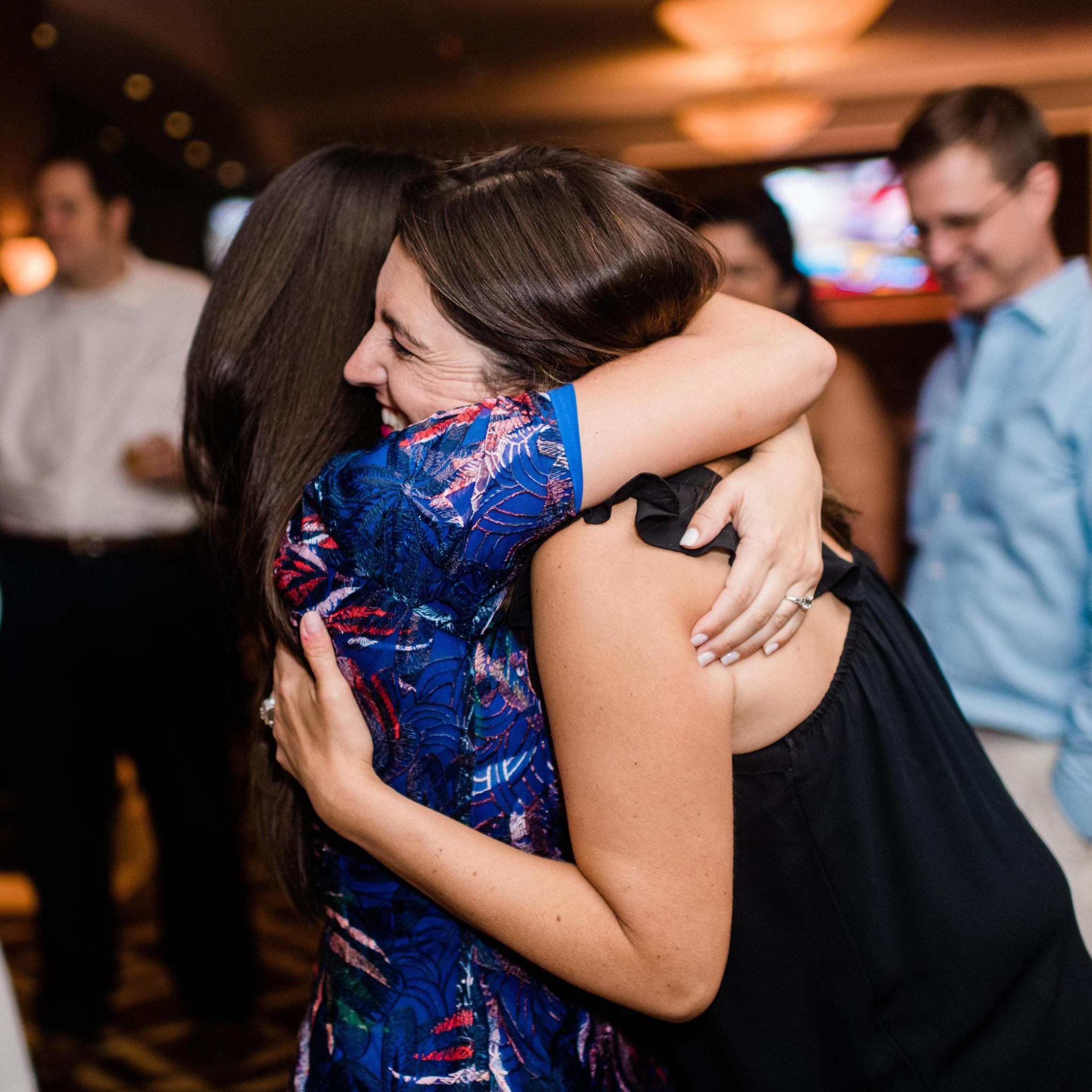Jennifer hugs her best friend Monica who does not yet know she will be asked to be Jennifer's Matron of Honor