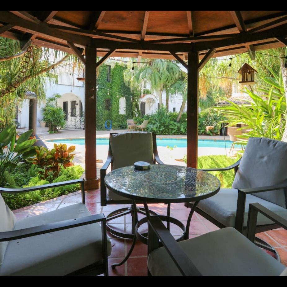 Historic home built in the 1920's has two buildings overlooking the pool.
