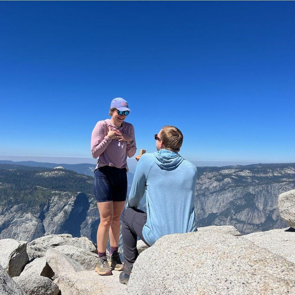 Engaged at the summit of Half Dome in Yosemite National Park