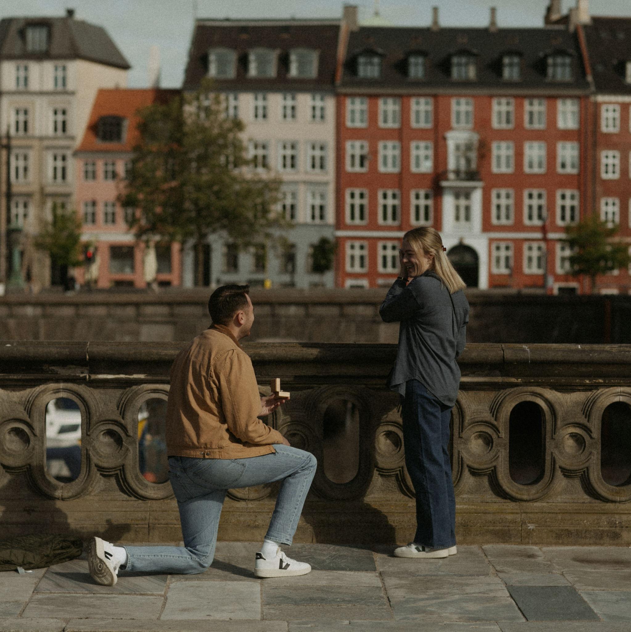 Taylor proposing on the Marble Bridge beside Christiansborg Palace on May 16, 2025