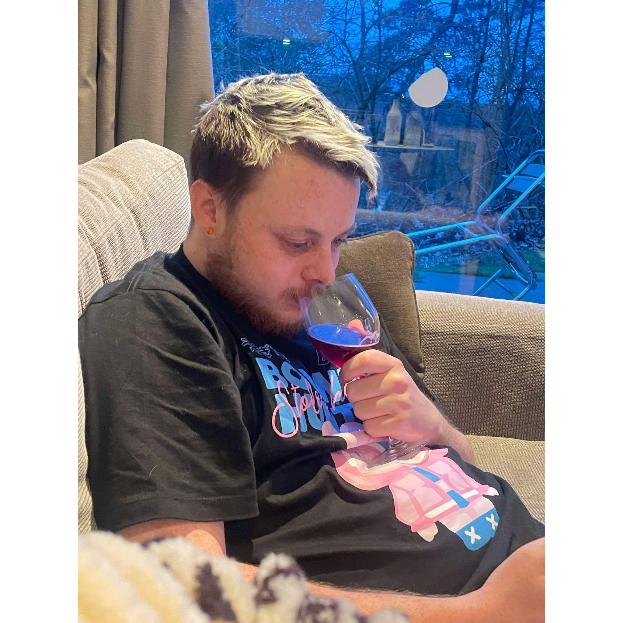 Enjoying his wine.
