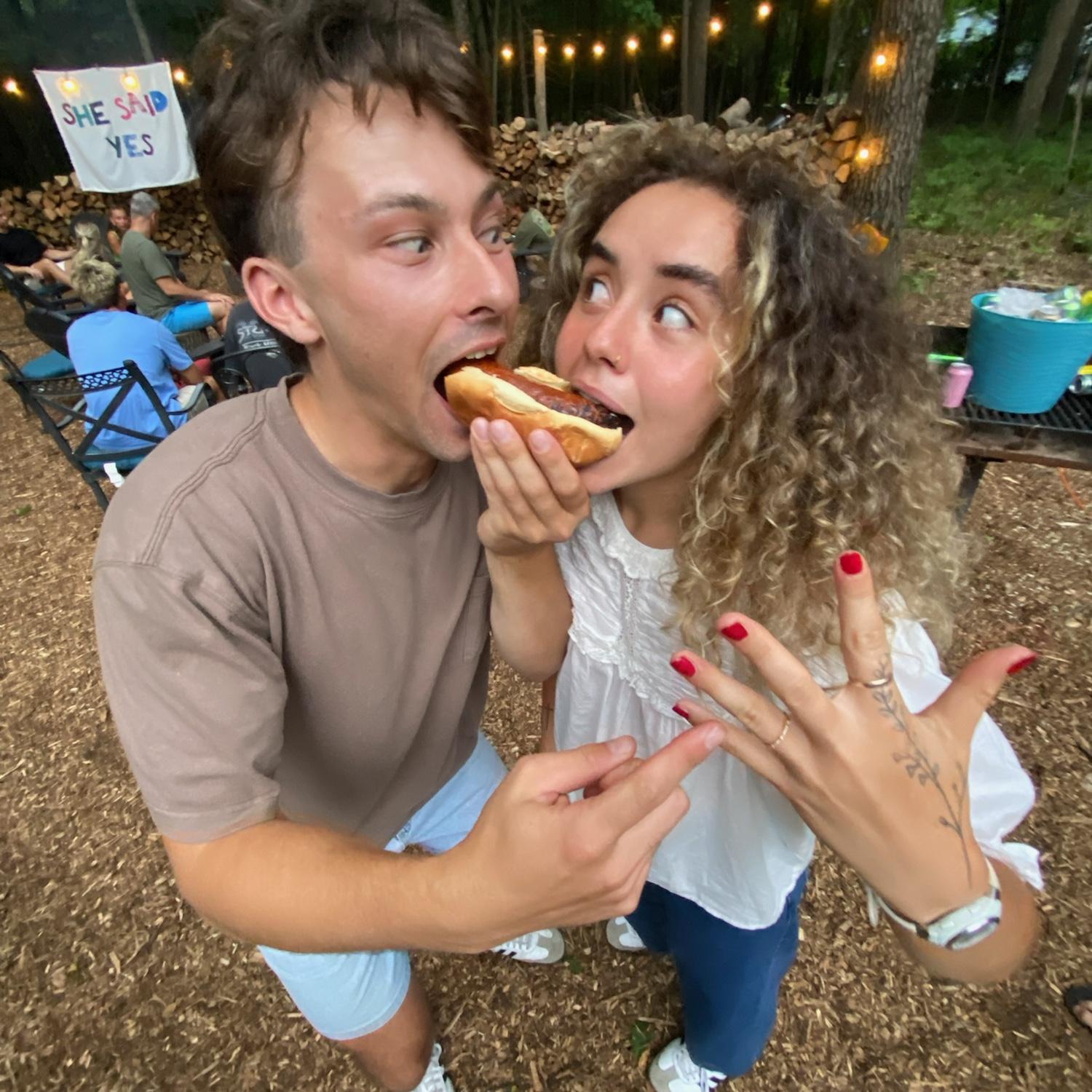 Aidan and Lizzy share a brat on the night of their engagement.
