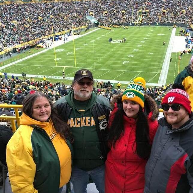 With Amanda's mom and dad at the Packer's game in 2019.