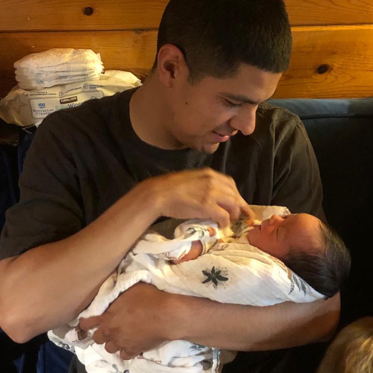 Daddy meeting baby boy for the first time at 3 days old.