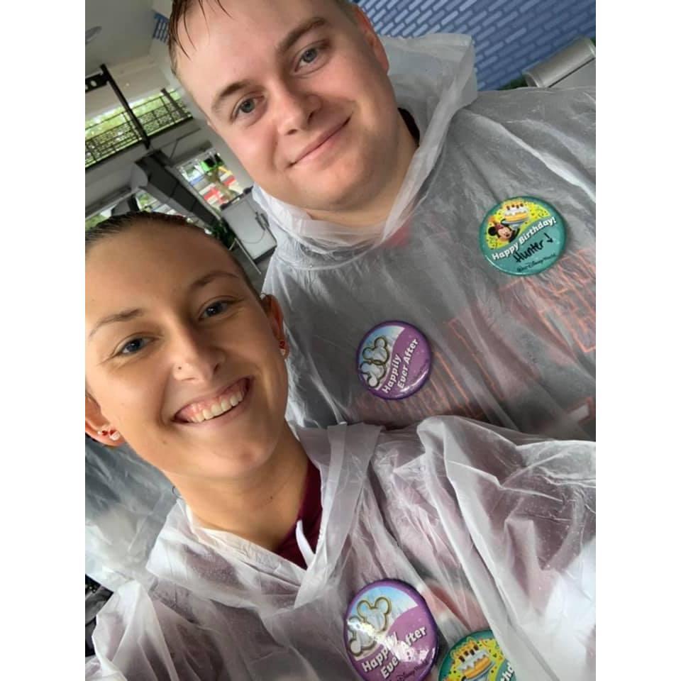Flaunting our birthday and engagement pins at Disney World!