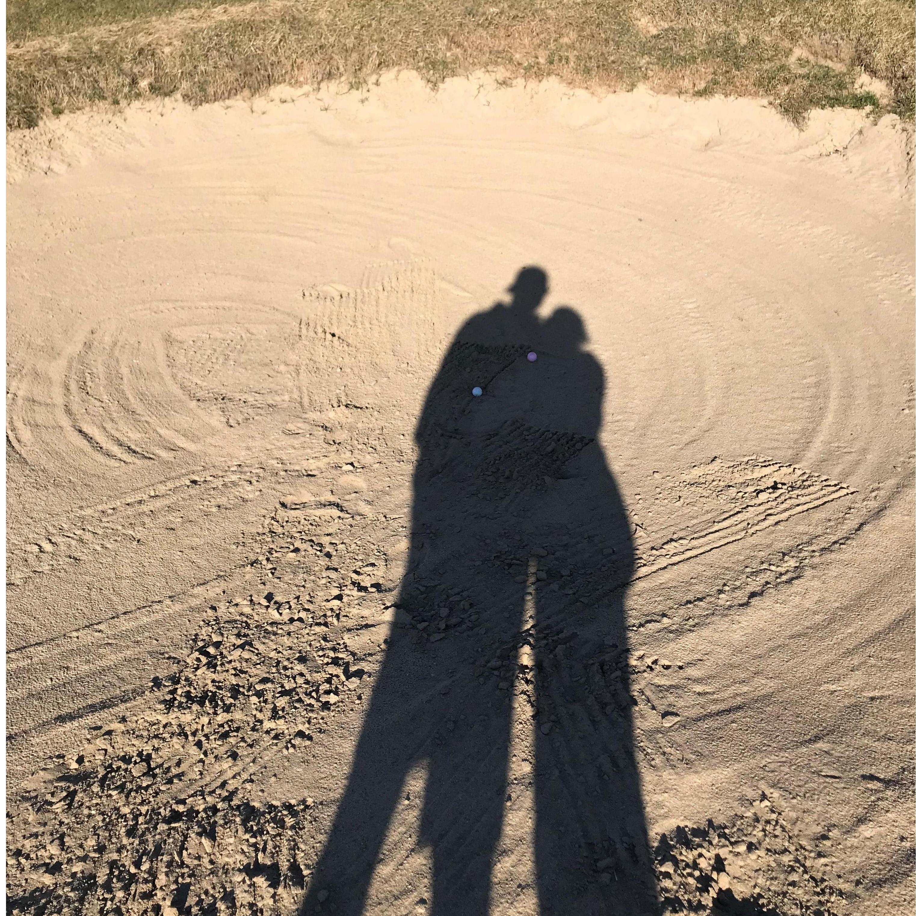 While golfing our balls both landed in the same sandpit.