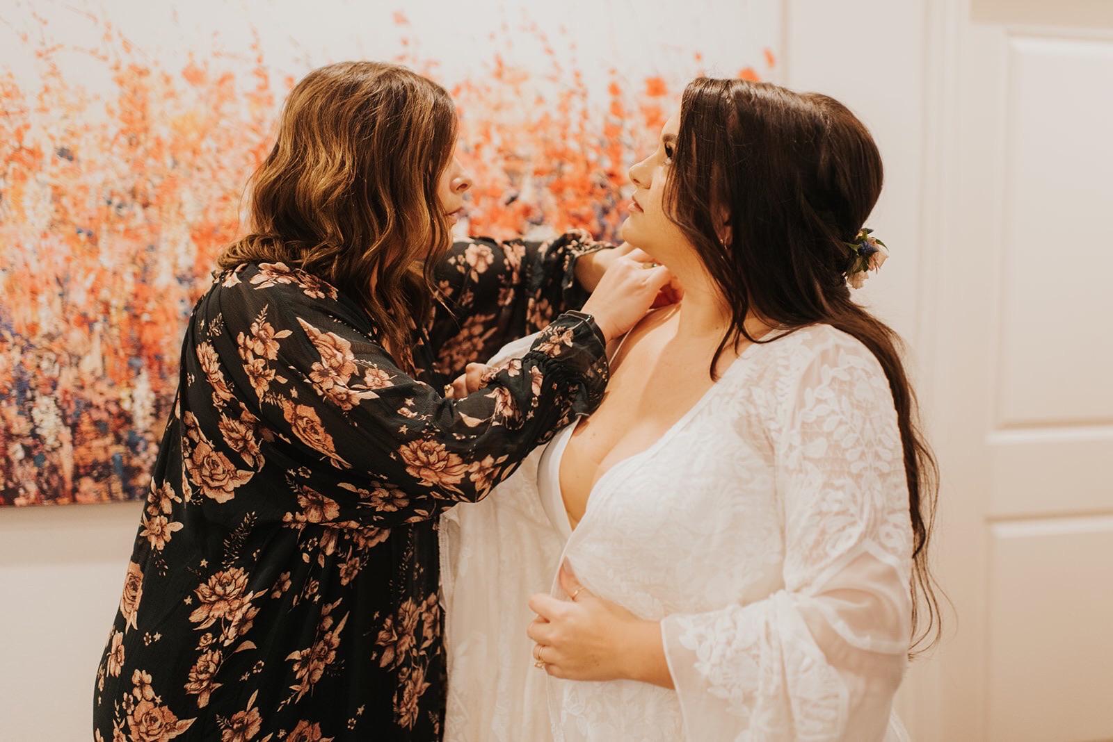 Tasha helping the bride with her dress