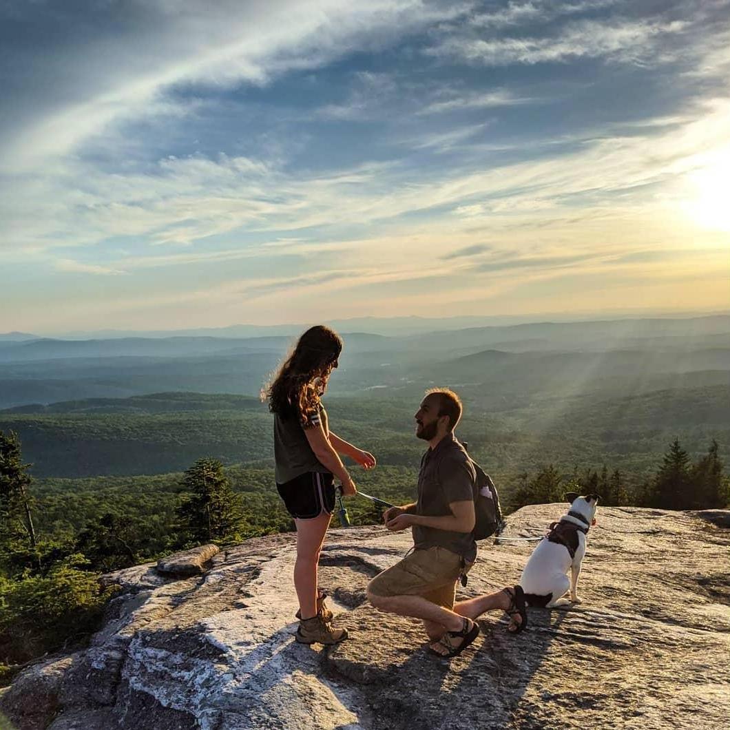 Adam popping the question on Mt. Cardigan at sunset.